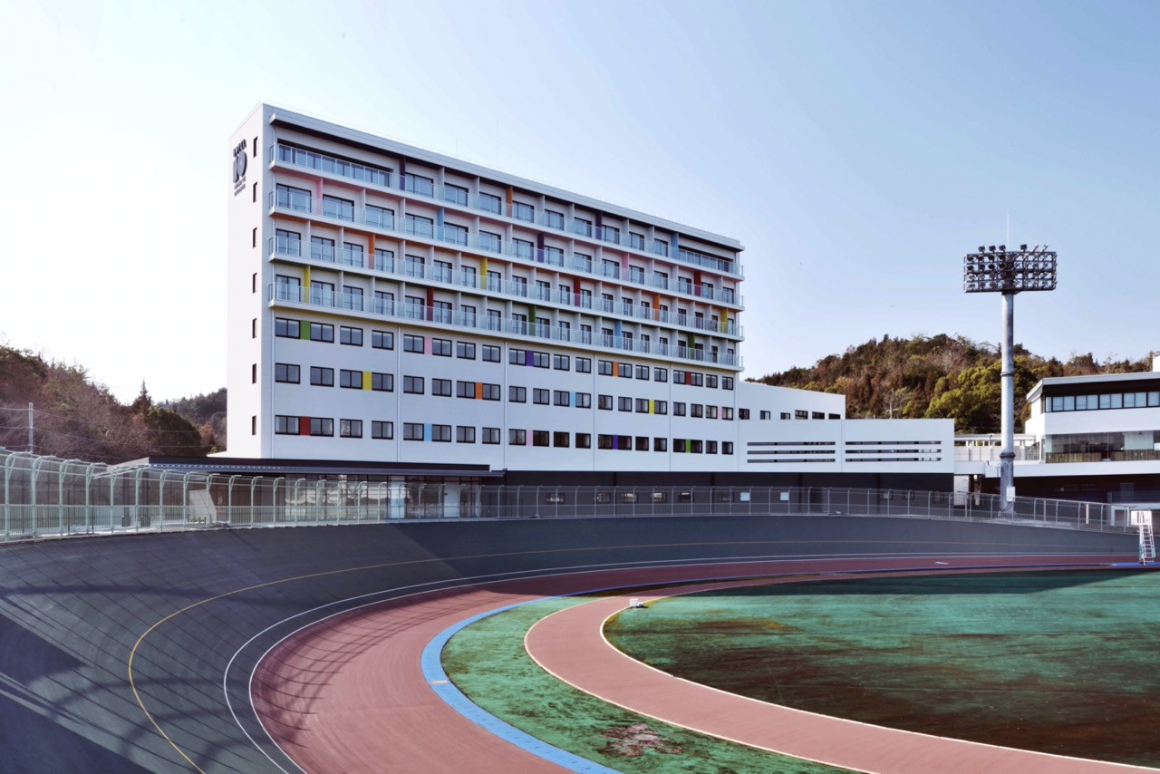 The hotel building stands adjacent to the renovated Tamano Keirin Stadium velodrome