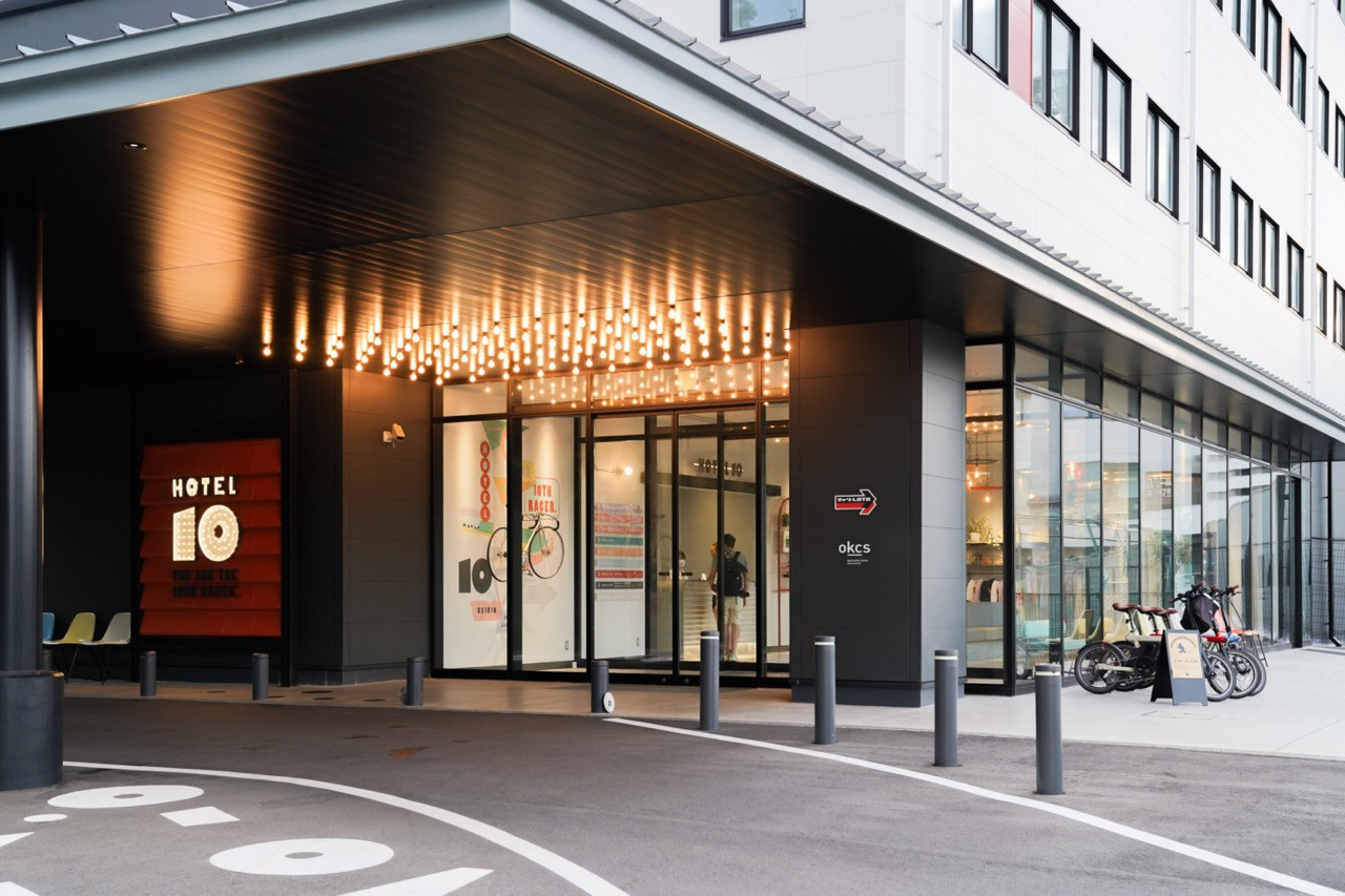 The hotel entrance has bicycle parking with materials repurposed from the original racetrack for both structure and decoration