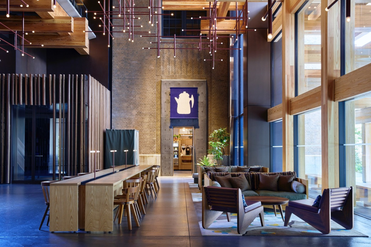 The Ace Hotel lobby features an exposed timber structure and artwork by Japanese textile artist Samiro Yunoki