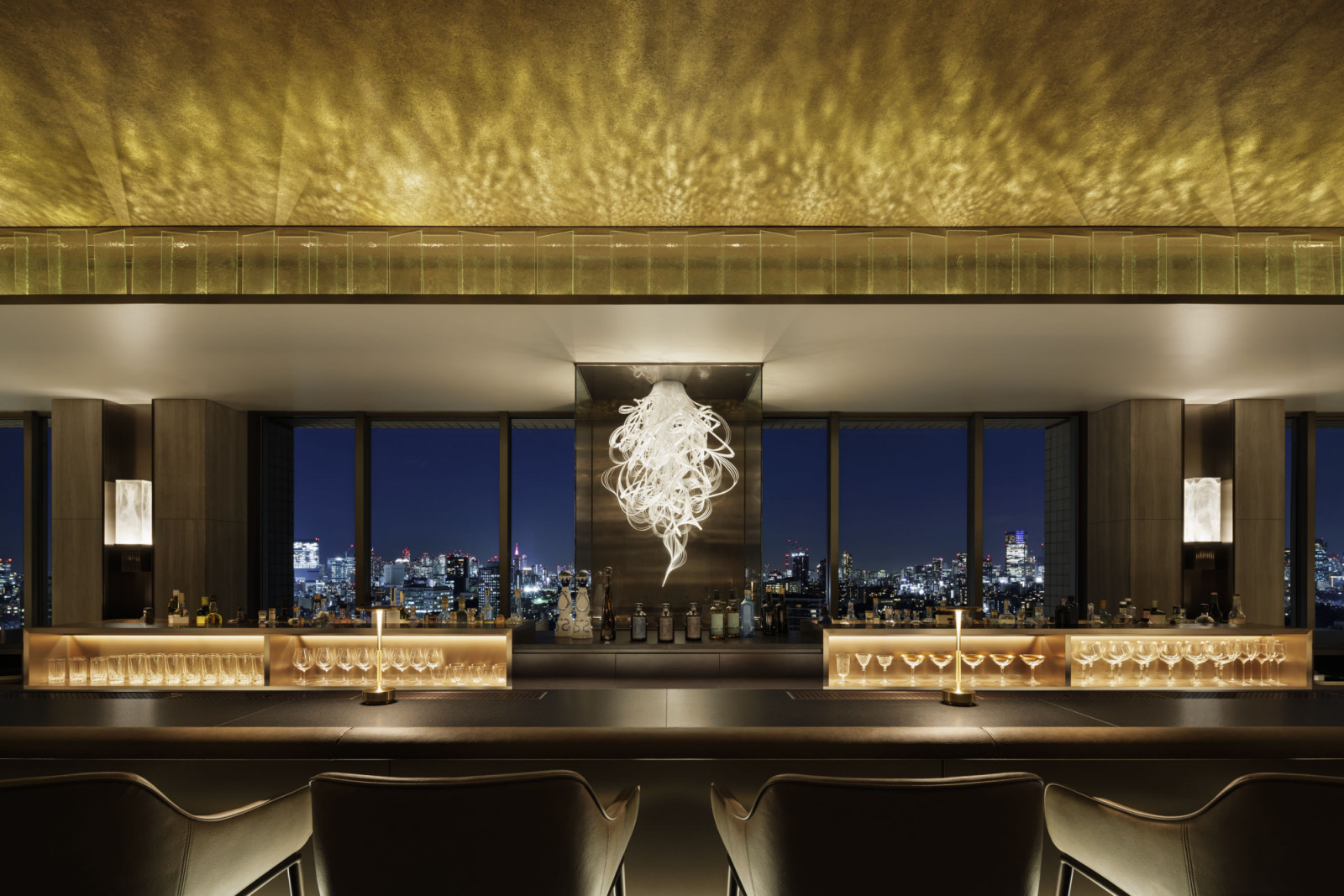 The bar on the top floor frames Tokyo's skyline through floor-to-ceiling windows