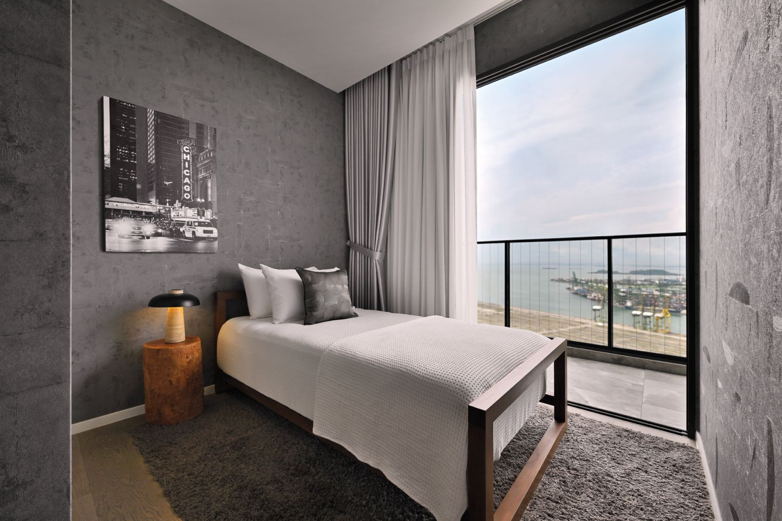 This simple yet beautifully decorated common bedroom opens out to a balcony with sweeping views of the water (Photo: EK Yap)