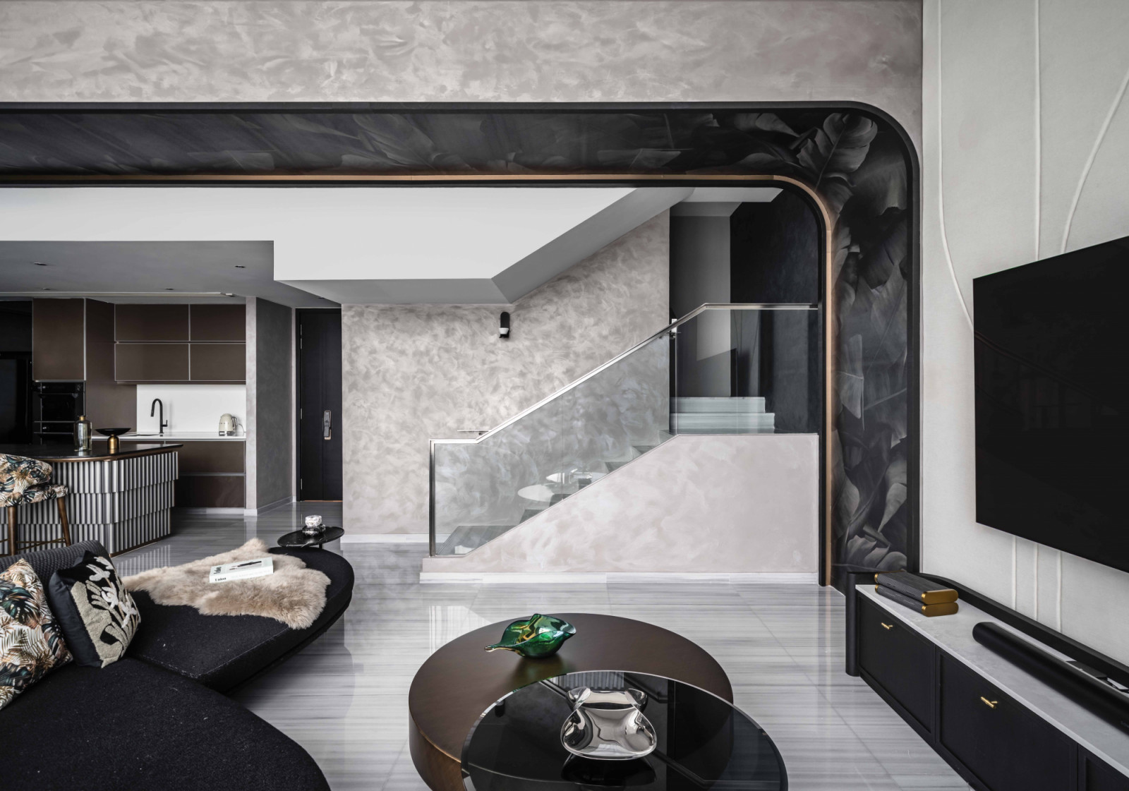 Curved forms and layered shades of grey and off-white enrich the penthouse’s monochromatic interior (Photo: Aaron Poon)