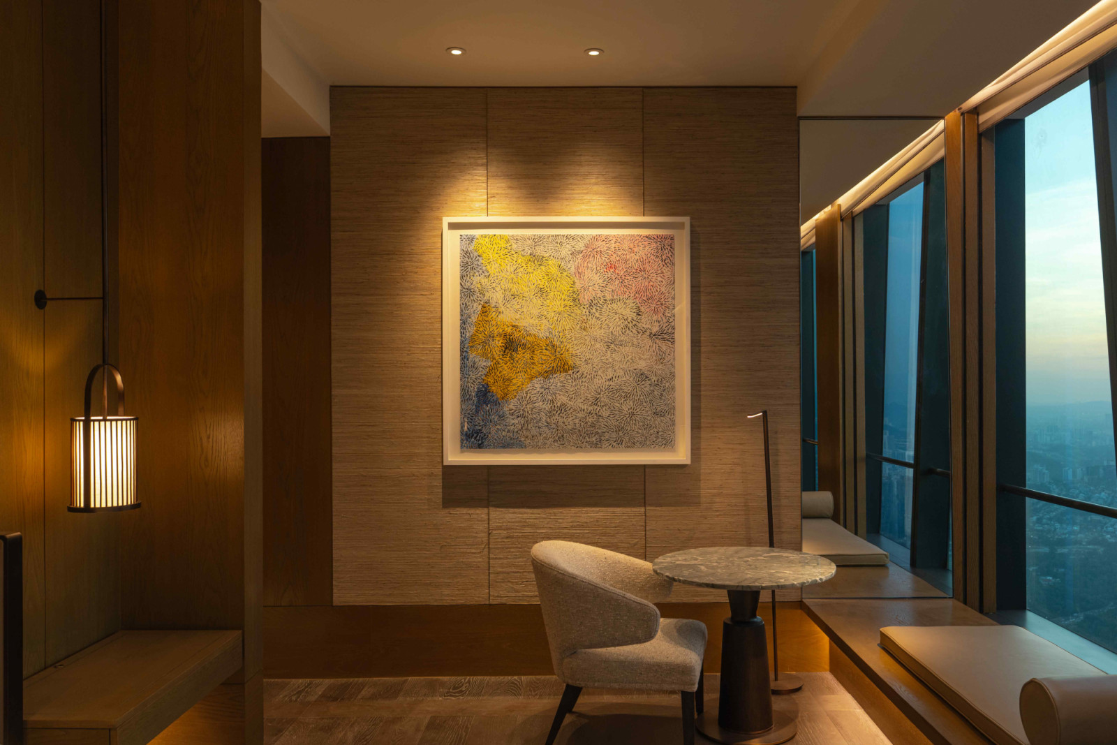 Deep daybeds along panoramic windows evoke private verandas