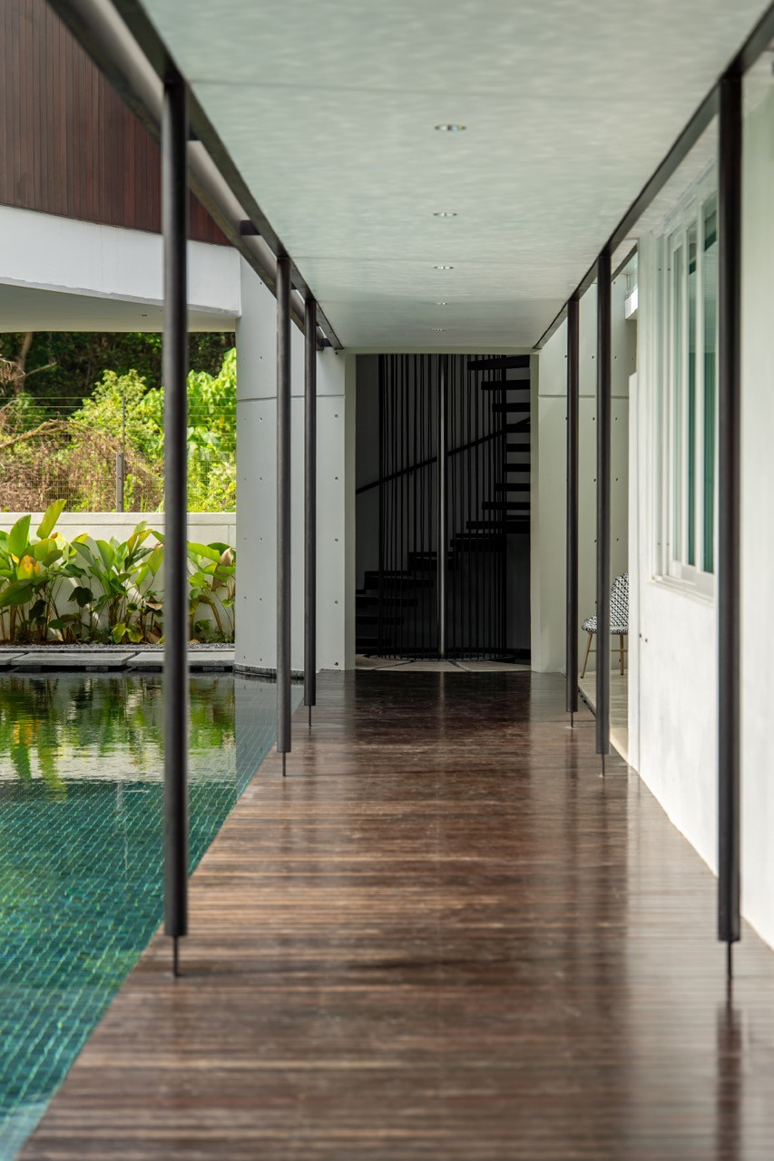 The covered walkway creates a transitional space between indoor and outdoor areas