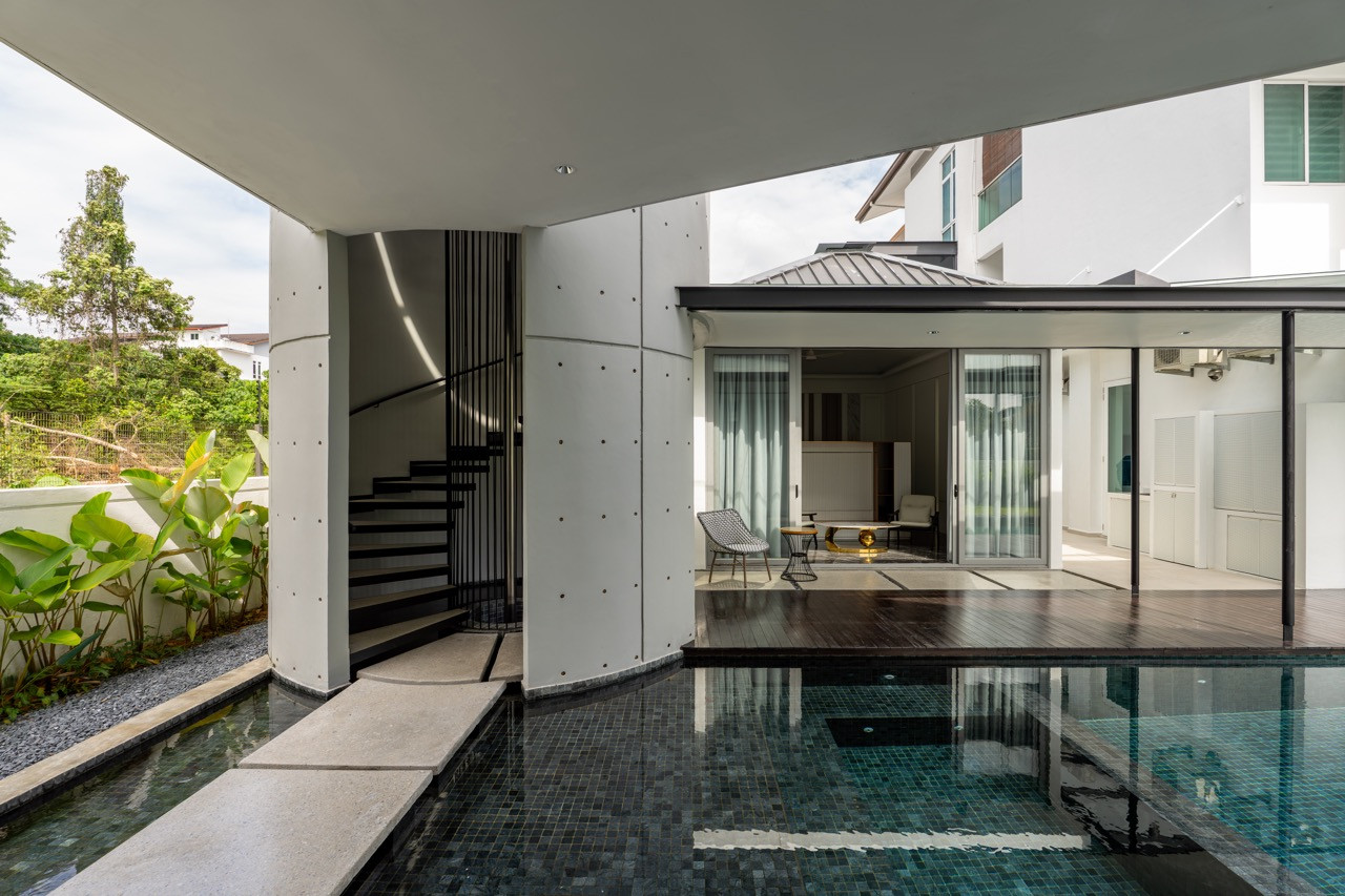 An elevated pathway crosses the reflecting pool between pavilions