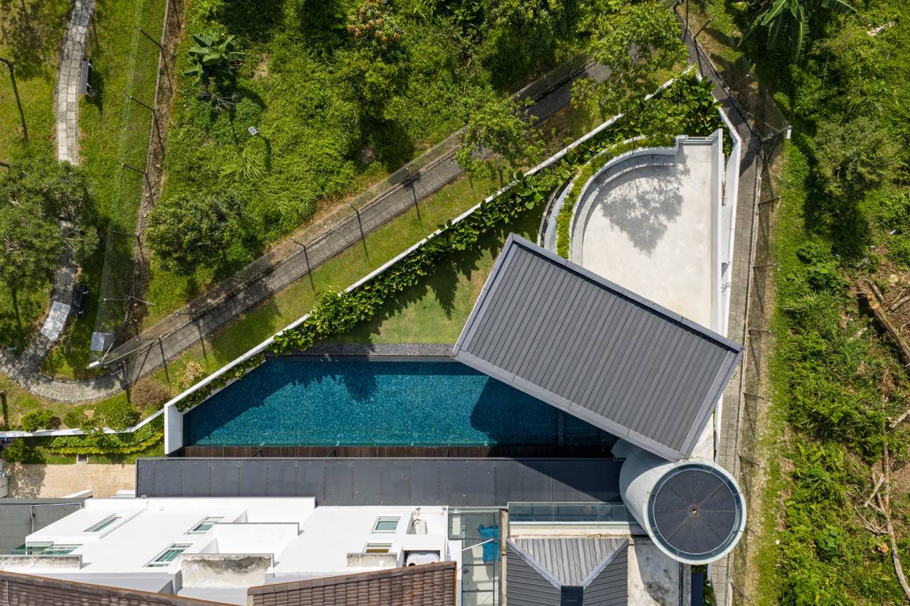 An aerial view shows the pavilions organised around the lap pool with the rooftop garden visible