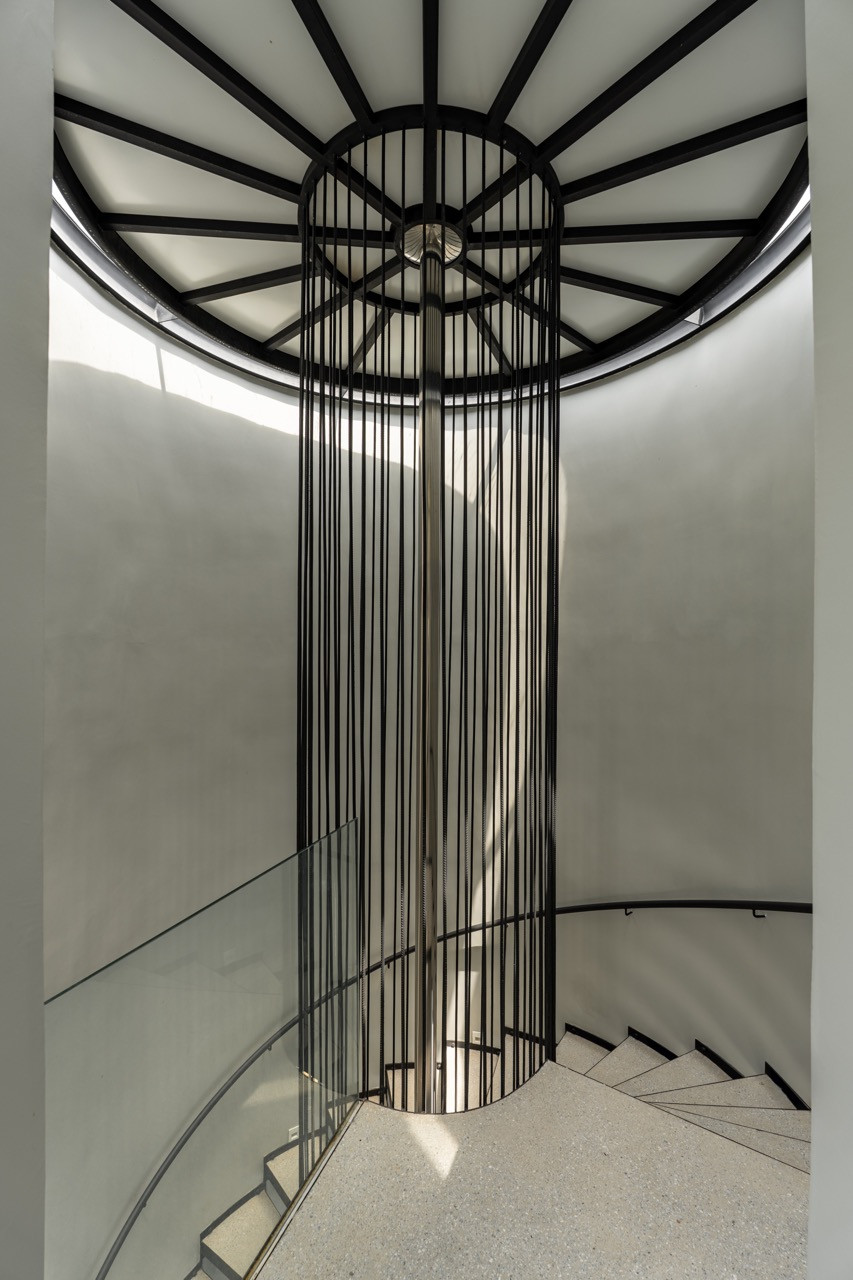 Looking up through the spiral staircase with its cylindrical metal cage