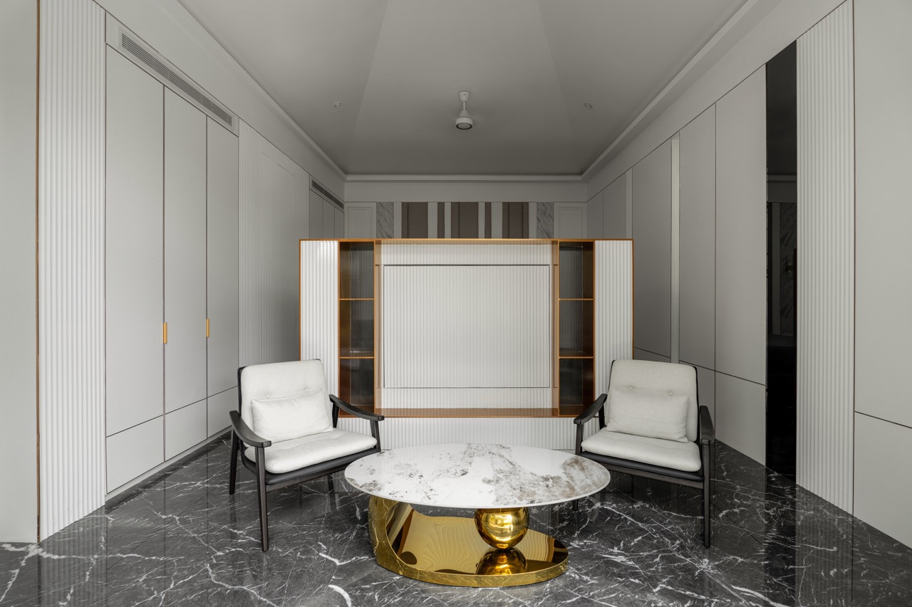 The same entertainment space reveals a television behind the retractable screen