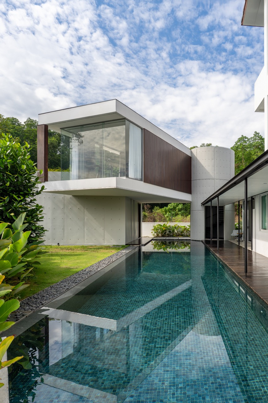 Concrete walkways traverse the pool connecting the separate pavilions