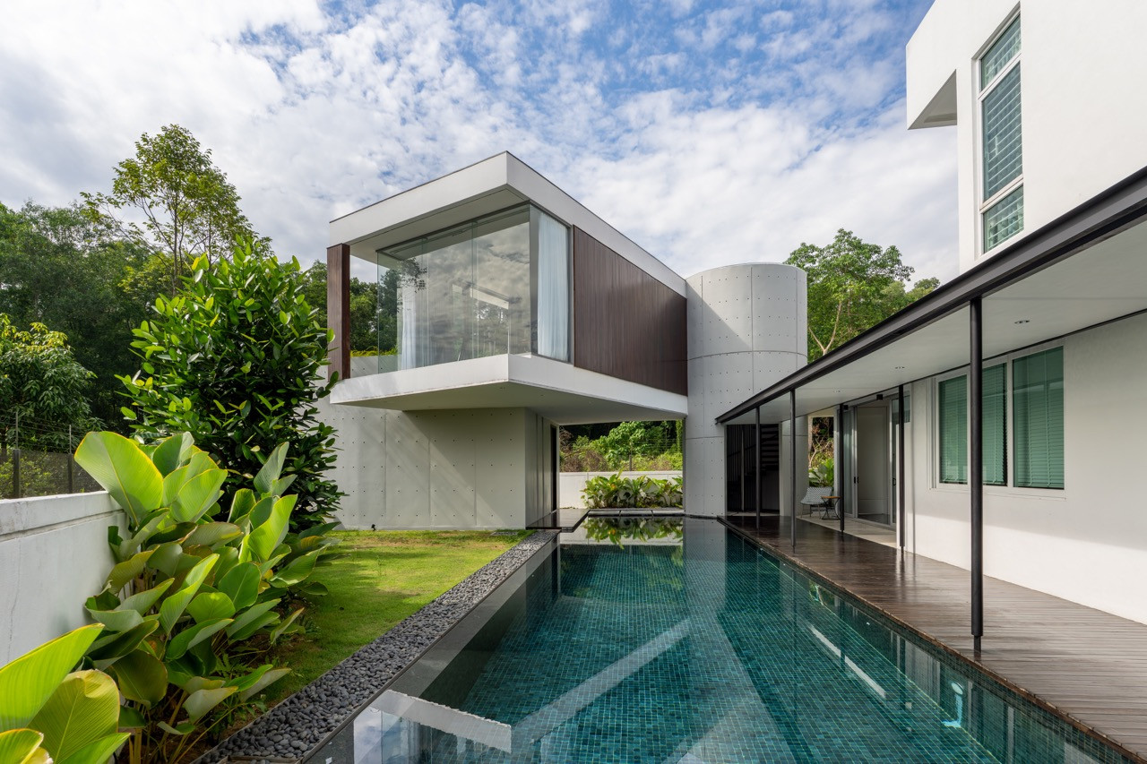 The 30-metre lap pool runs between the concrete staircase tower and the original house