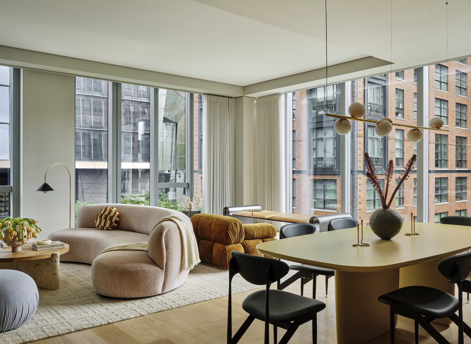 A living room with organic shapes and neutral hues at a pied-à-terre above the High Line in New York City designed by Lucy Harris