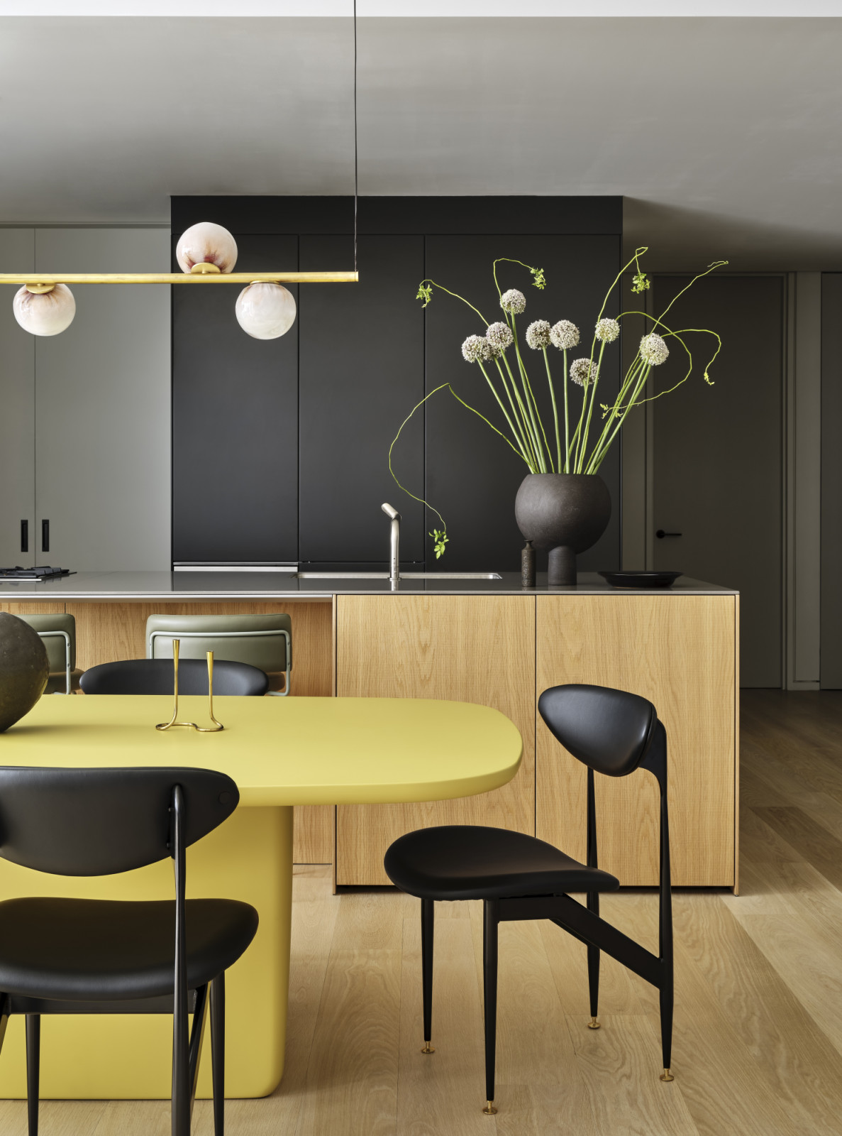 A dining room and kitchen with playful pops of colour at a pied-à-terre above the High Line in New York City designed by Lucy Harris