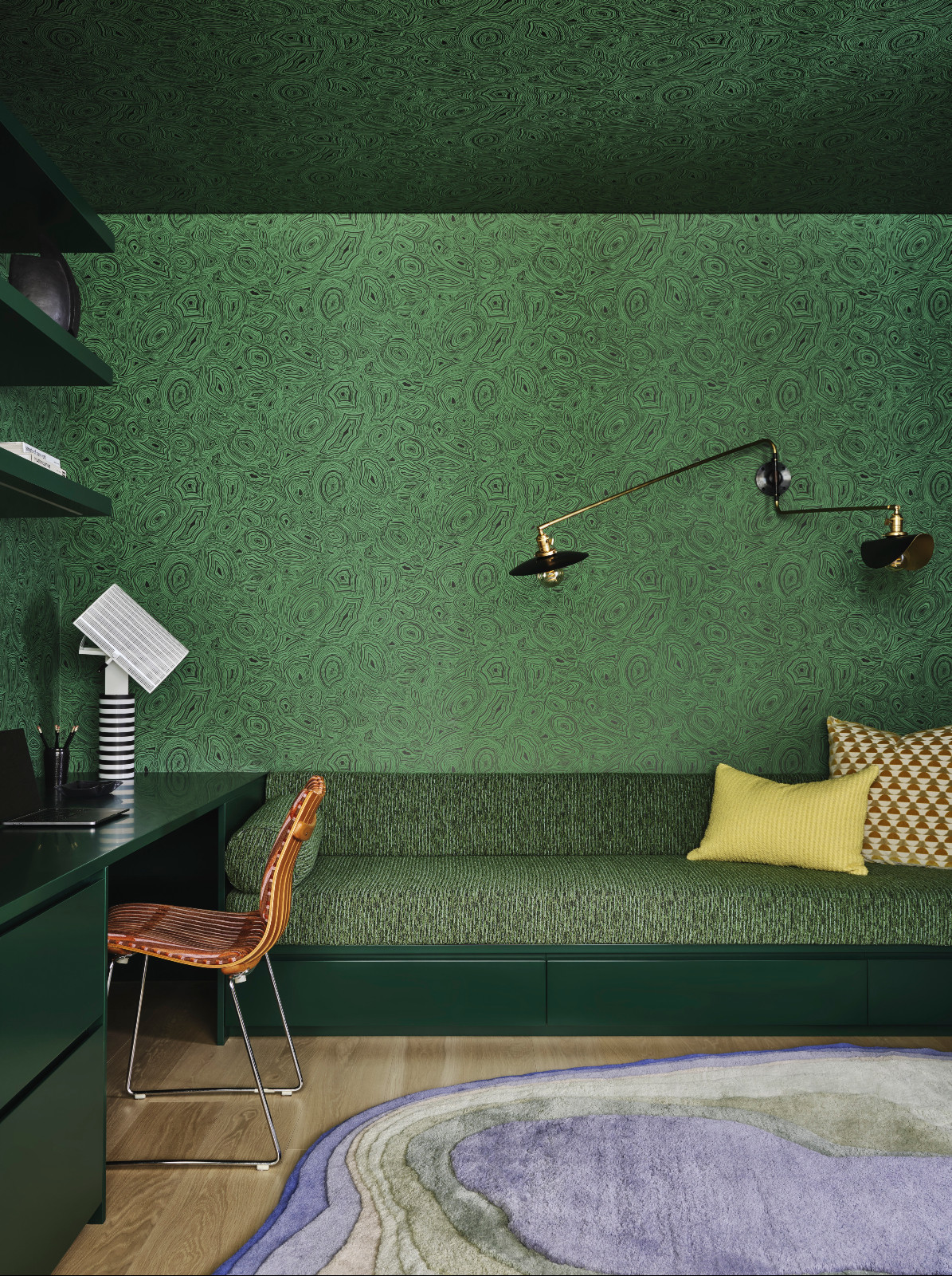 A study with a botanical, jewel-toned wallpaper at a pied-à-terre above the High Line in New York City designed by Lucy Harris