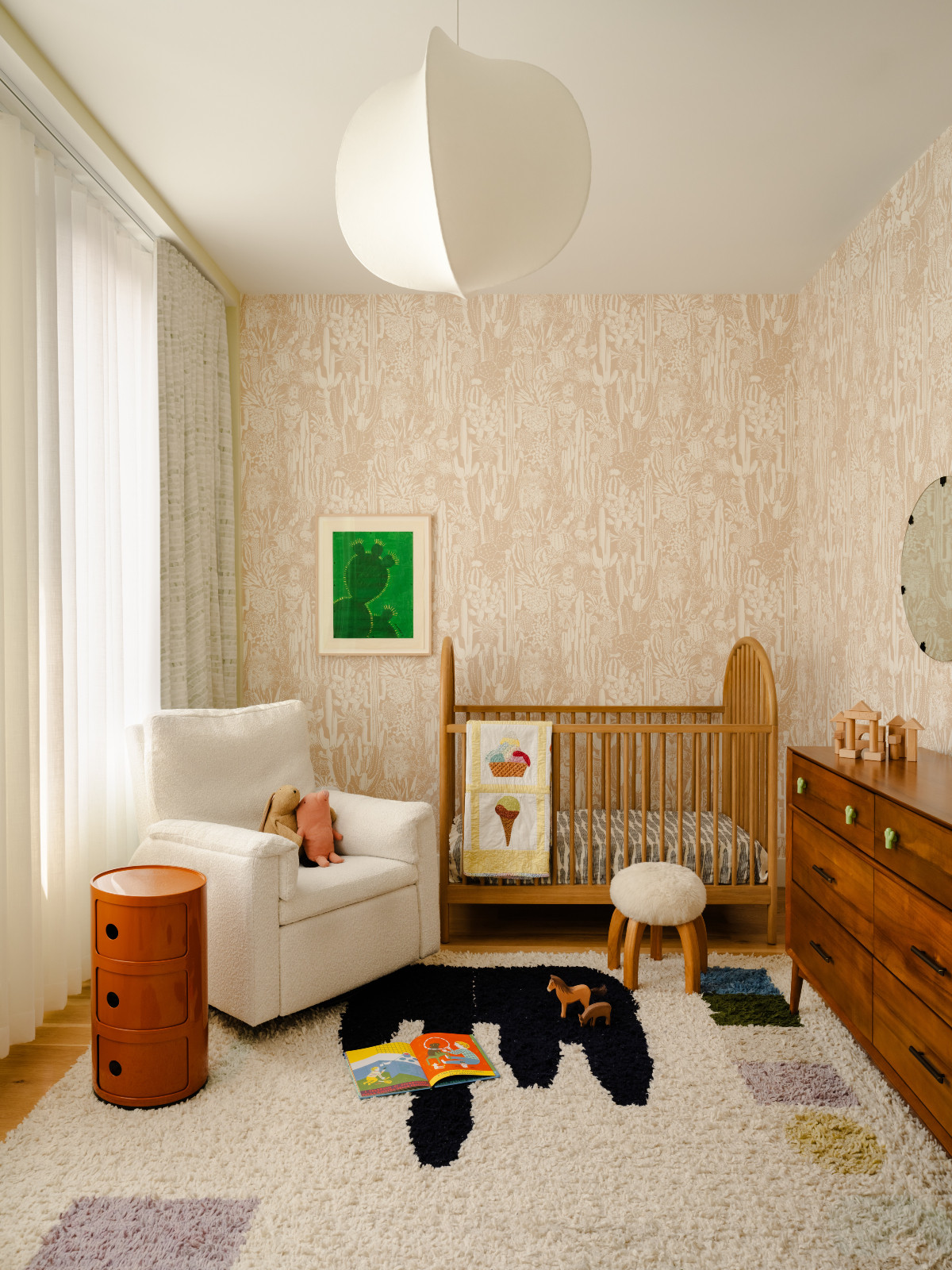 The nursery of a Brooklyn townhouse designed by Lucy Harris, highlighting the warm materiality of wood with pops of colour and organic textures