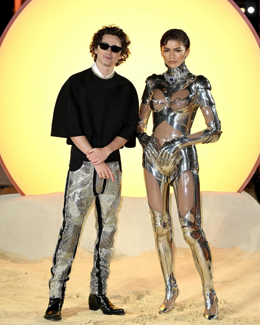 Zendaya and Timothée Chalamet translate the film’s desert-futurism into sleek, structured couture, embodying their characters beyond the screen (Photo: @dunemovie / Instagram)