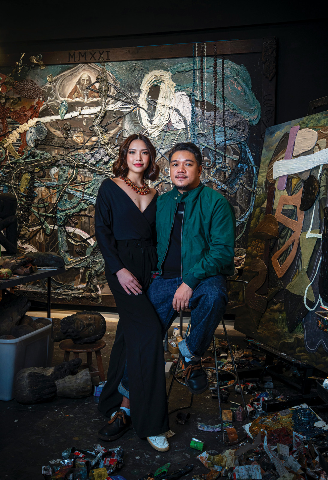 Cruz with partner, Aira Hernandez in front of 'Rhetorical Paradigm As Poetry' (left) and an untitled painting in the works (right)