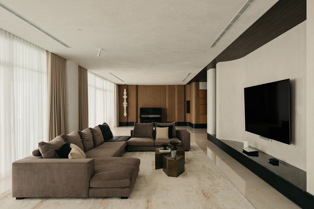 The living area shows the relationship between the seating, media wall and exterior windows