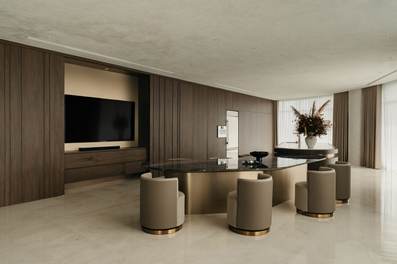 A view from the dining area shows the media wall, built-in shelving and timber cabinetry
