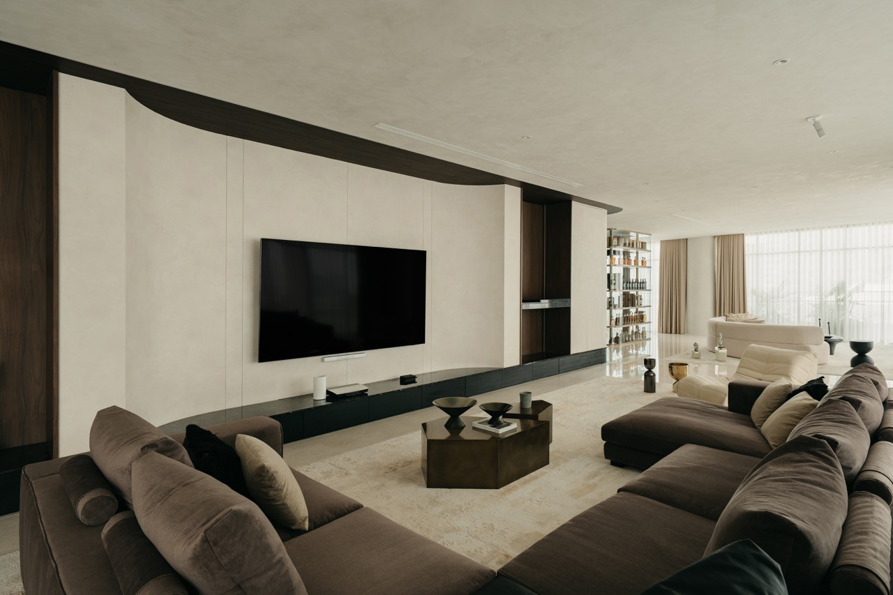 The living room faces the media wall with the spirits cabinet visible in the distance