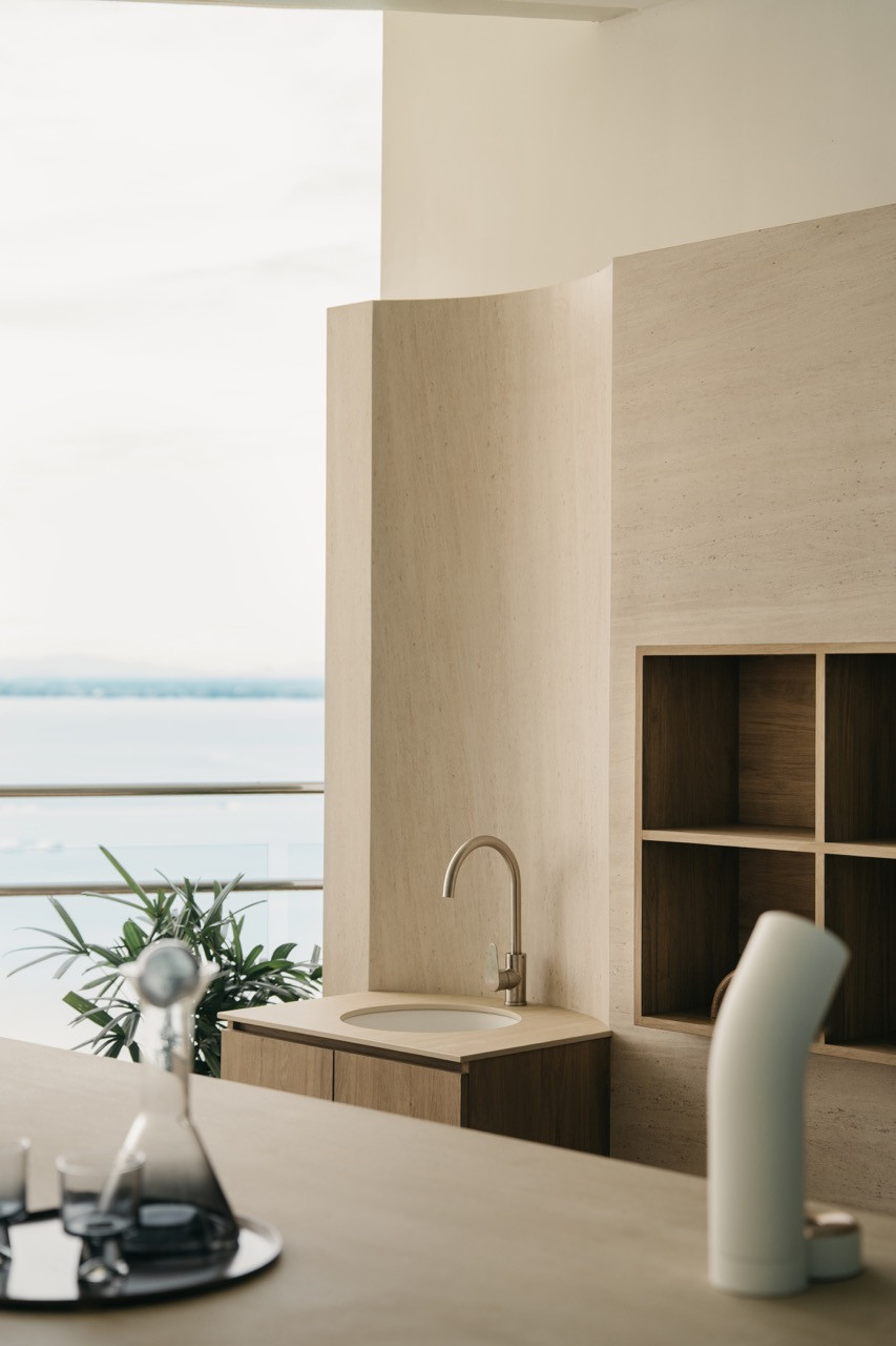 The balcony prep area shows the relationship among the sink, timber storage, and the glass railing
