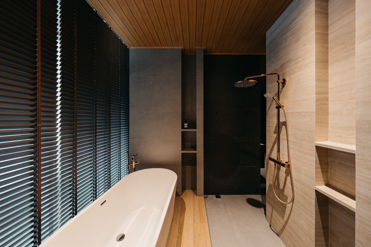 The master bathroom shows the relationship between the bathtub area, dual showers and vanity spaces