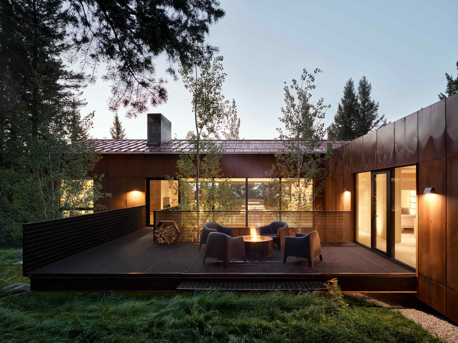 The rear metal-grate deck that encircles a pair of Aspen trees