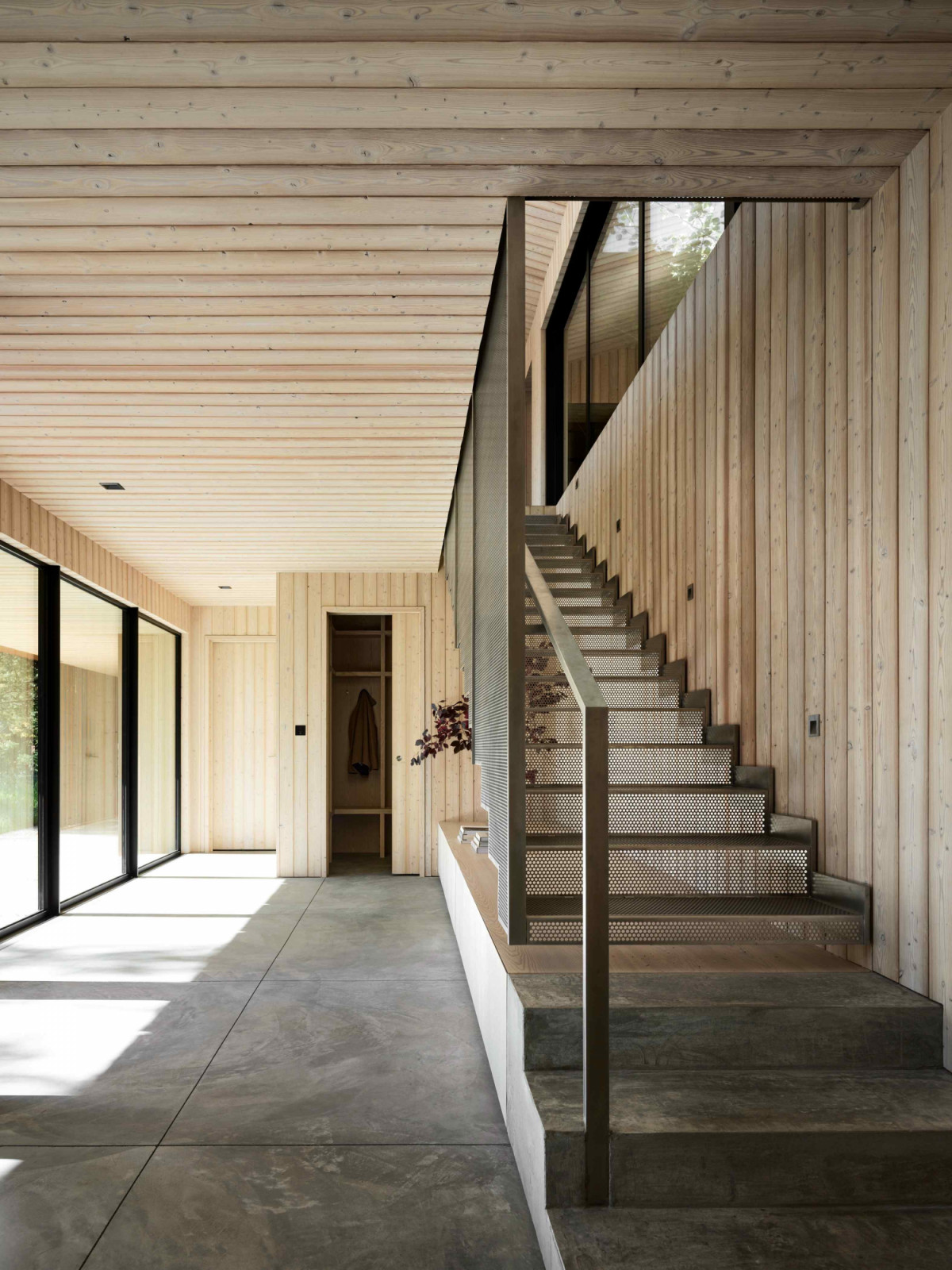 The lower level houses the practical spaces: the garage, mudroom, and gym