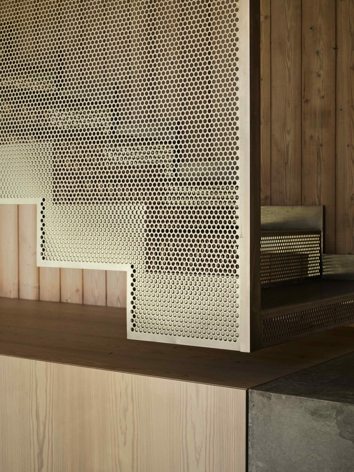 The floating staircase with perforated, stainless steel steps