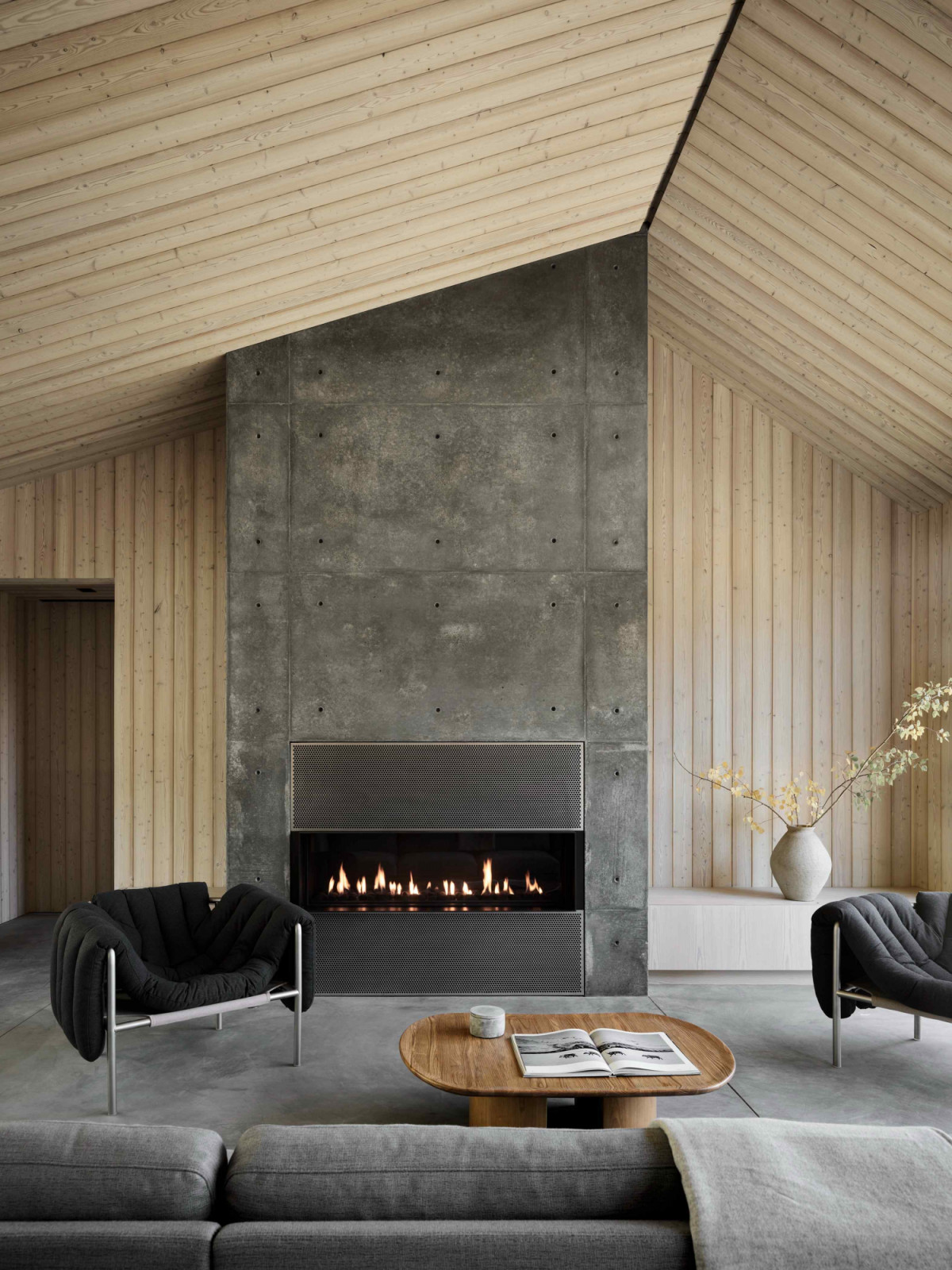 Larch wood extends to the interior walls and ceilings, grounded by concrete materials