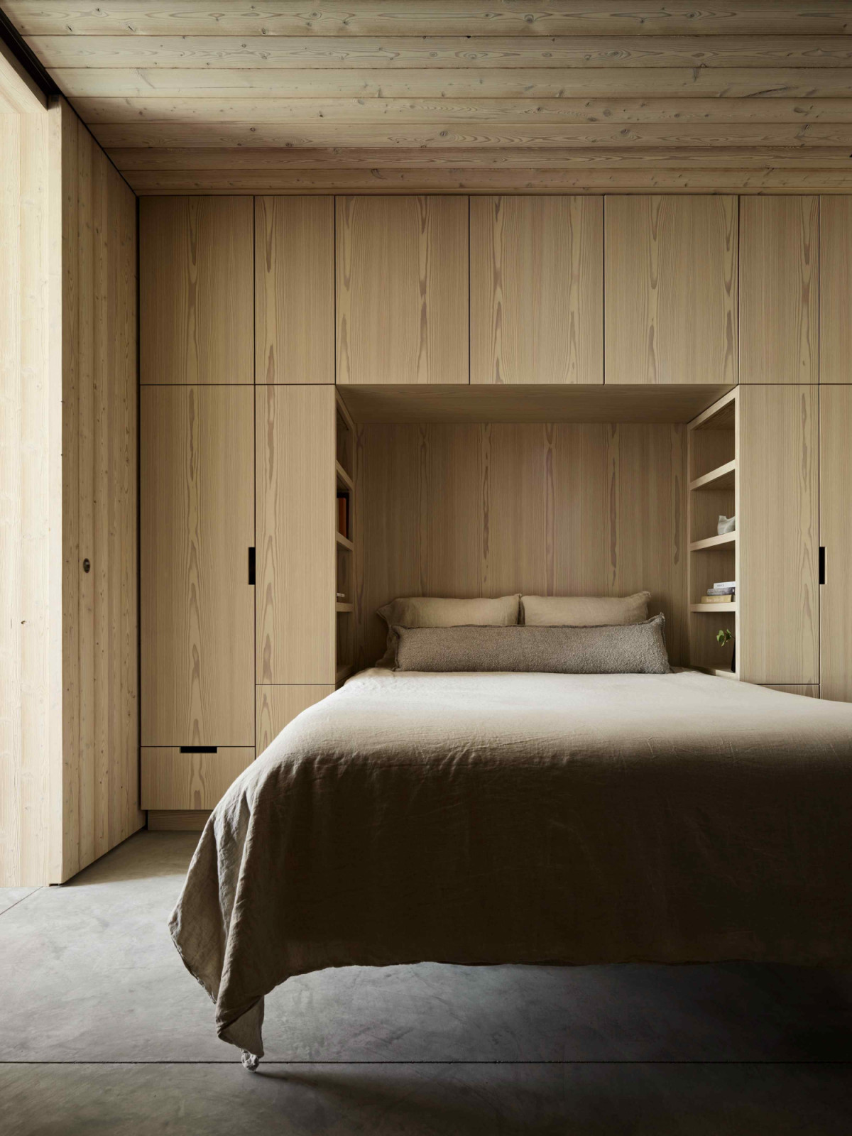 The bedroom built-in blends seamlessly with larch wood