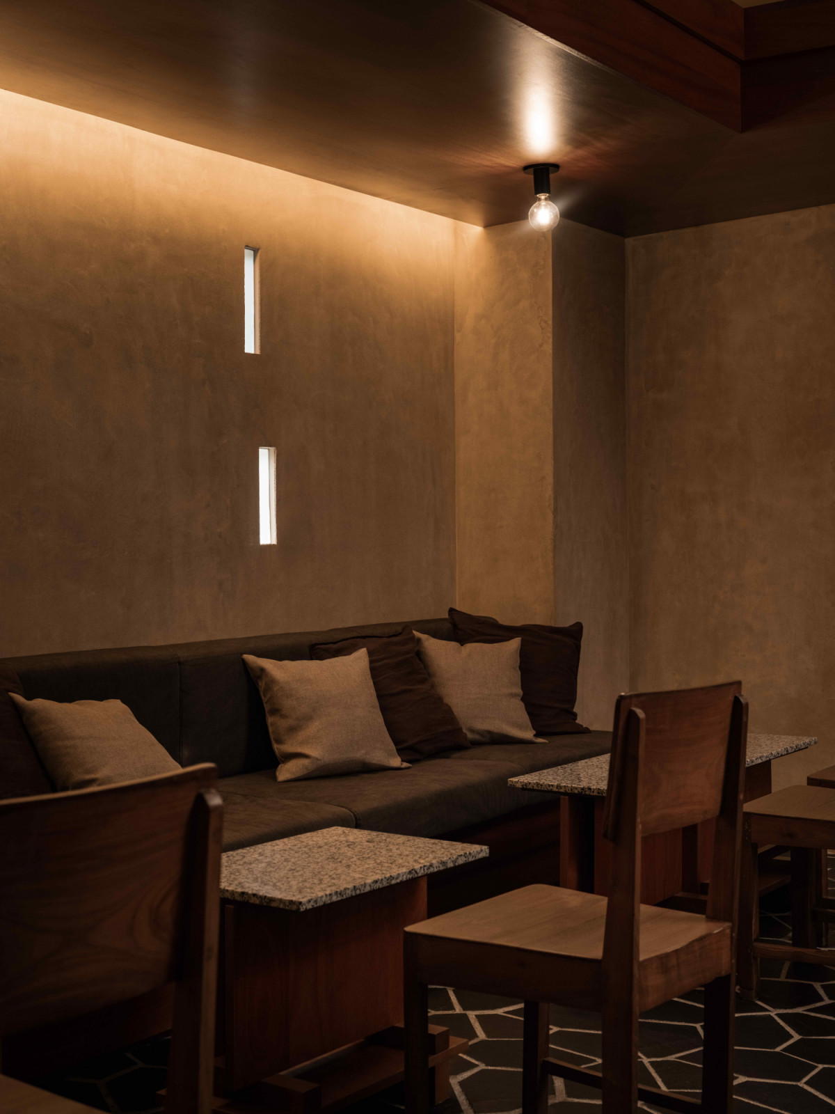 Wood grains and stone-like finishes form an elemental backdrop (Photo: TWJPTO)