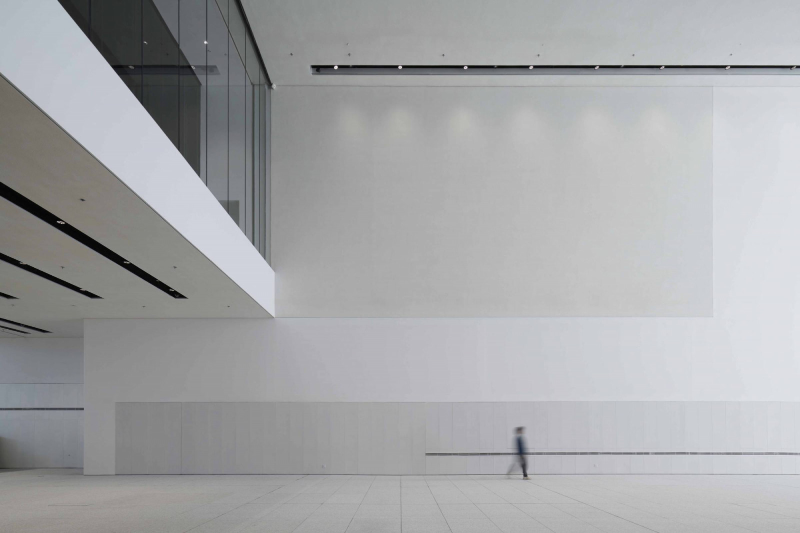 The central atrium rises through multiple levels, connecting 10,000 square metres of exhibition space. White walls and minimal detailing allow the architecture to recede behind displayed artworks whilst maintaining spatial clarity across floors (Photo: Chen Hao)