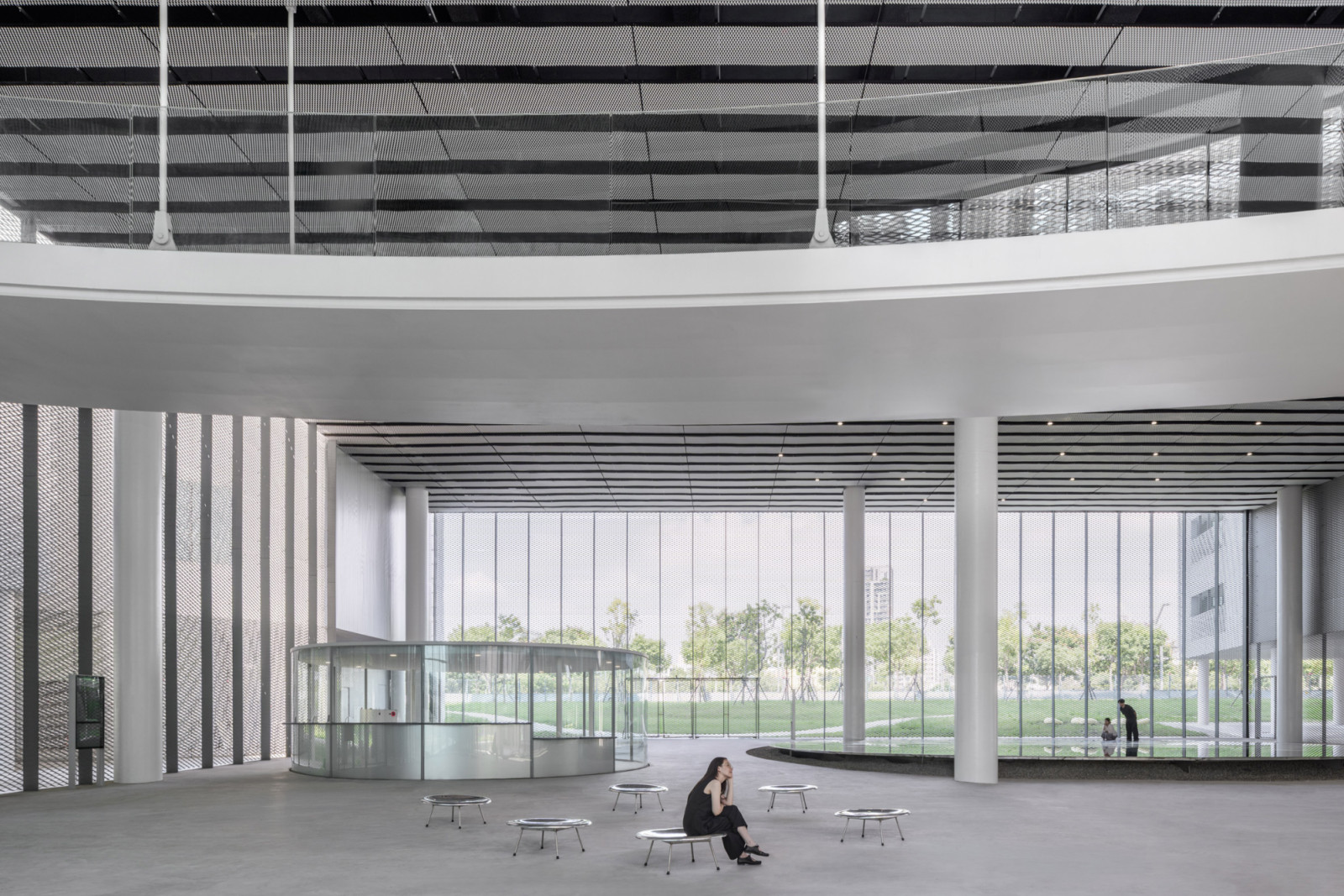 The building’s transparent envelope allows park visitors to see library and museum activities from exterior pathways, encouraging public engagement with cultural programming (Photo: YHLAA)
