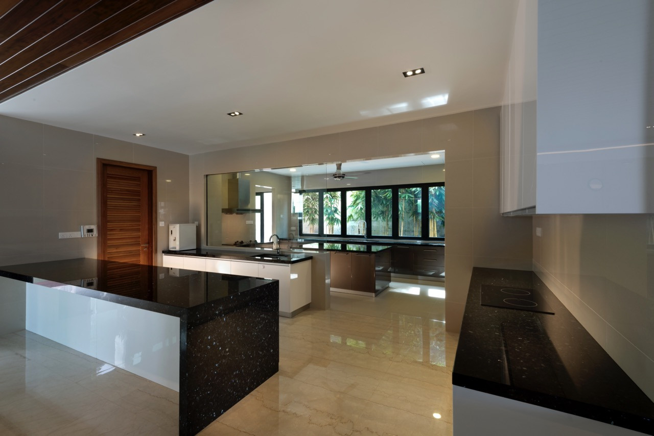The kitchen features black granite countertops and an island bench with timber ceiling panels that add warmth above the white cabinetry