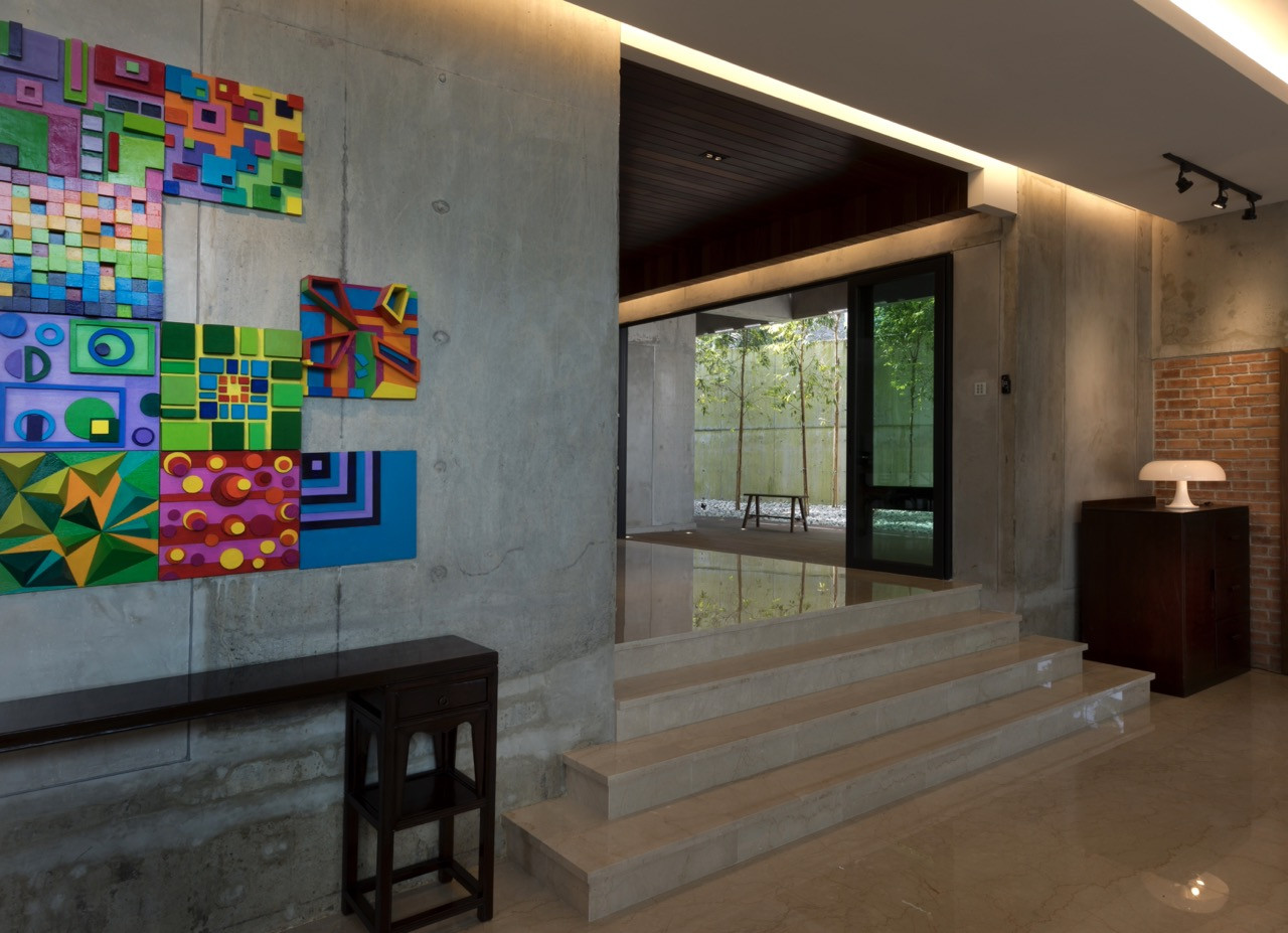 Marble steps lead up towards the internal courtyard, visible through the dark timber-framed opening
