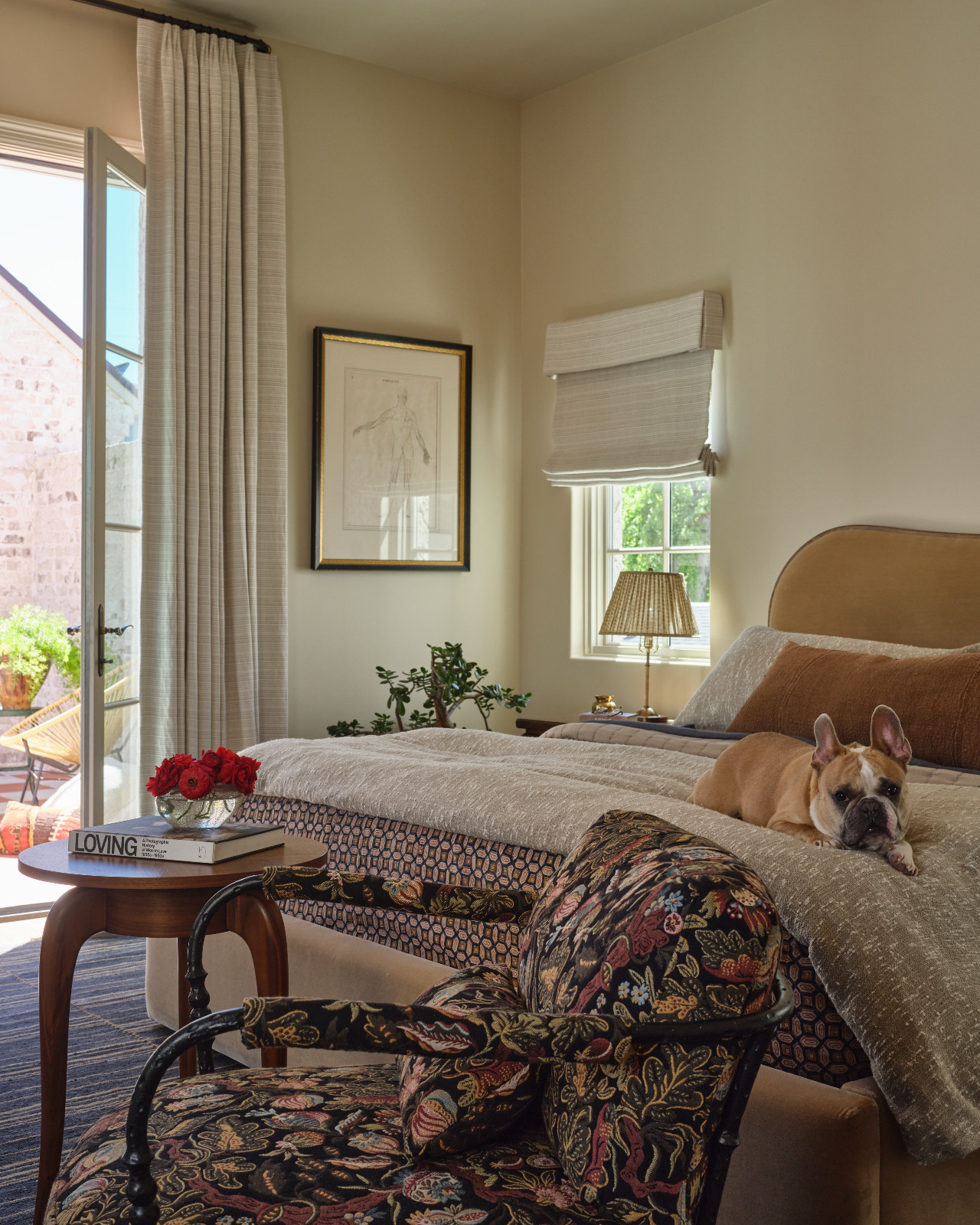 The primary bedroom with neutral hues and natural lighting in a home designed by Shane & Pierce in Dallas, Texas