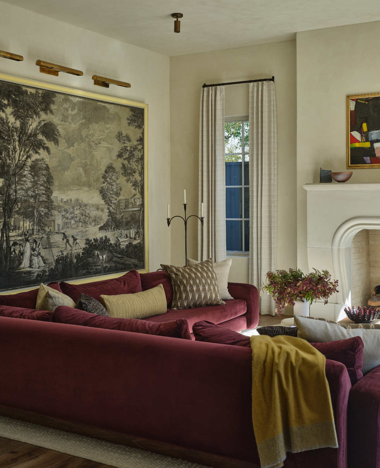 The tapestry behind the sofa in a living room designed by Shane & Pierce in Dallas, Texas