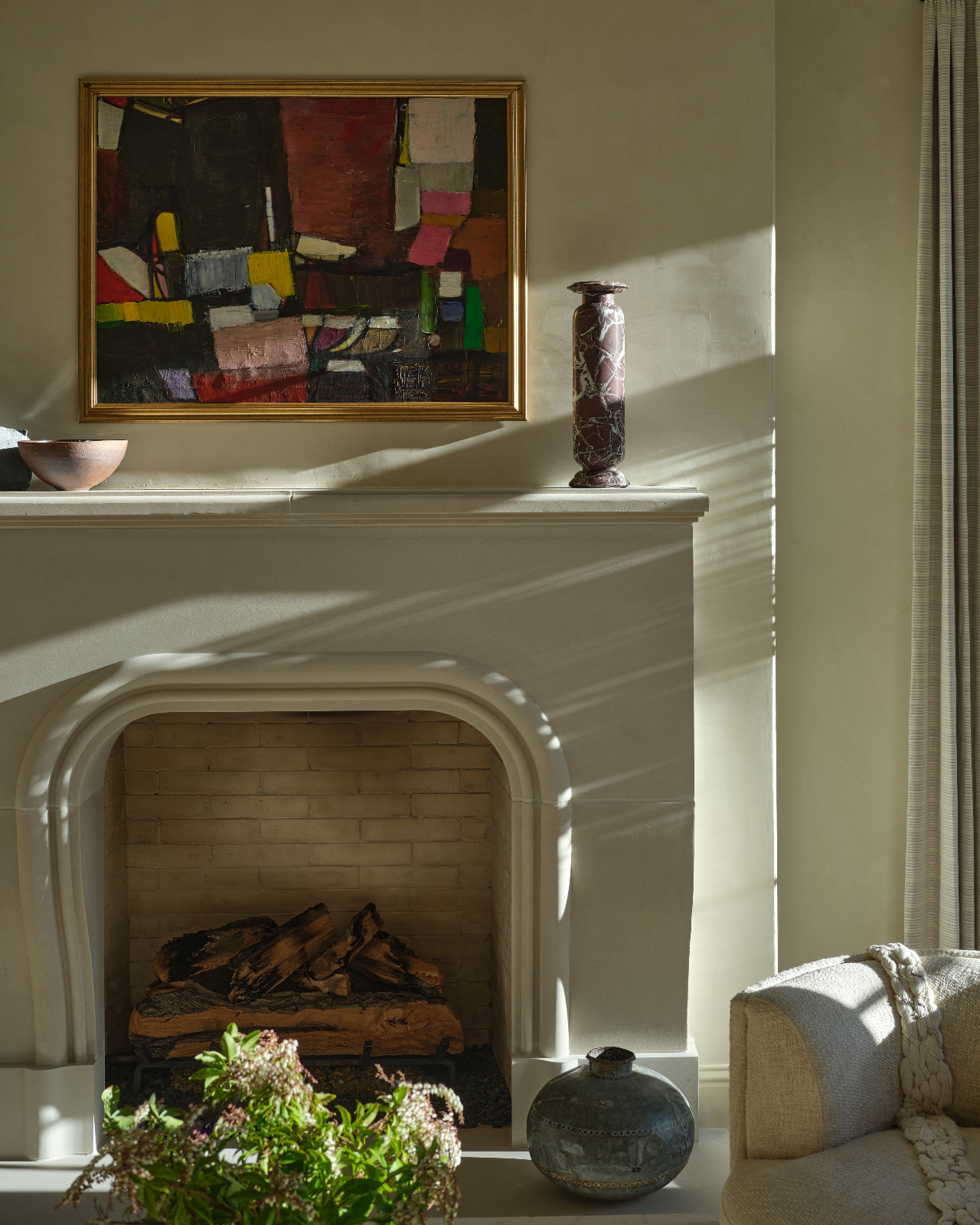 The fireplace in the living room designed by Shane & Pierce in Dallas, Texas