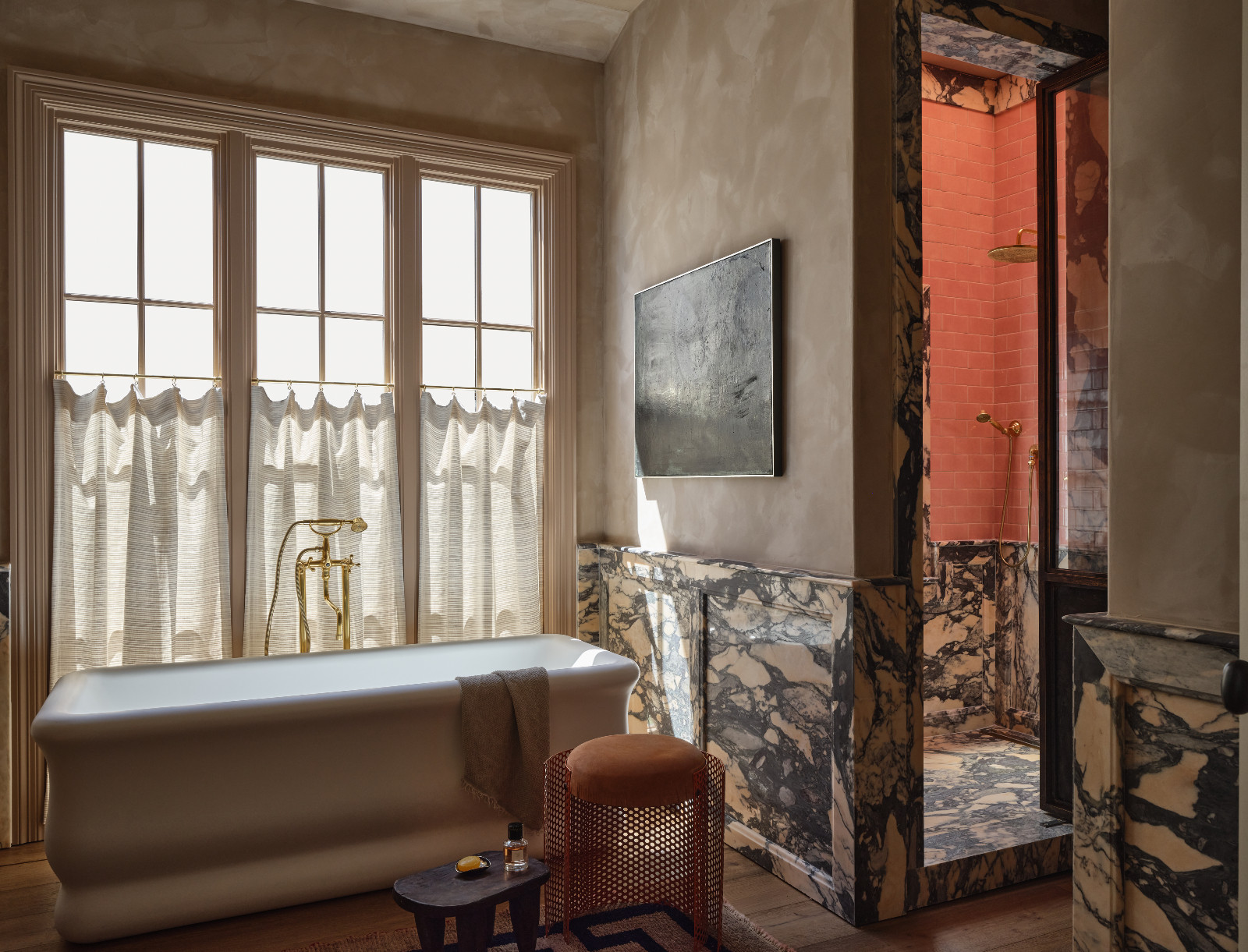 The primary bathroom with marble textures in a home designed by Shane & Pierce in Dallas, Texas