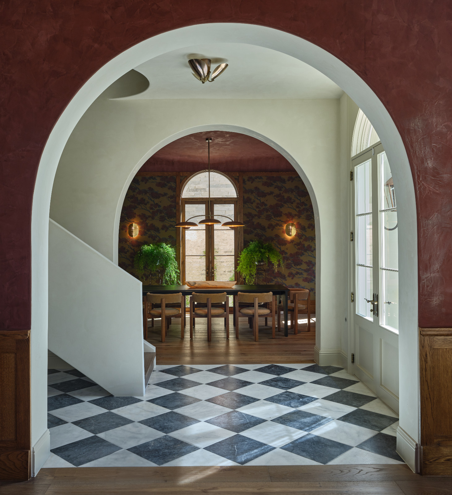 The arched entryway leadign to the dining room in a home designed by Shane & Pierce in Dallas, Texas