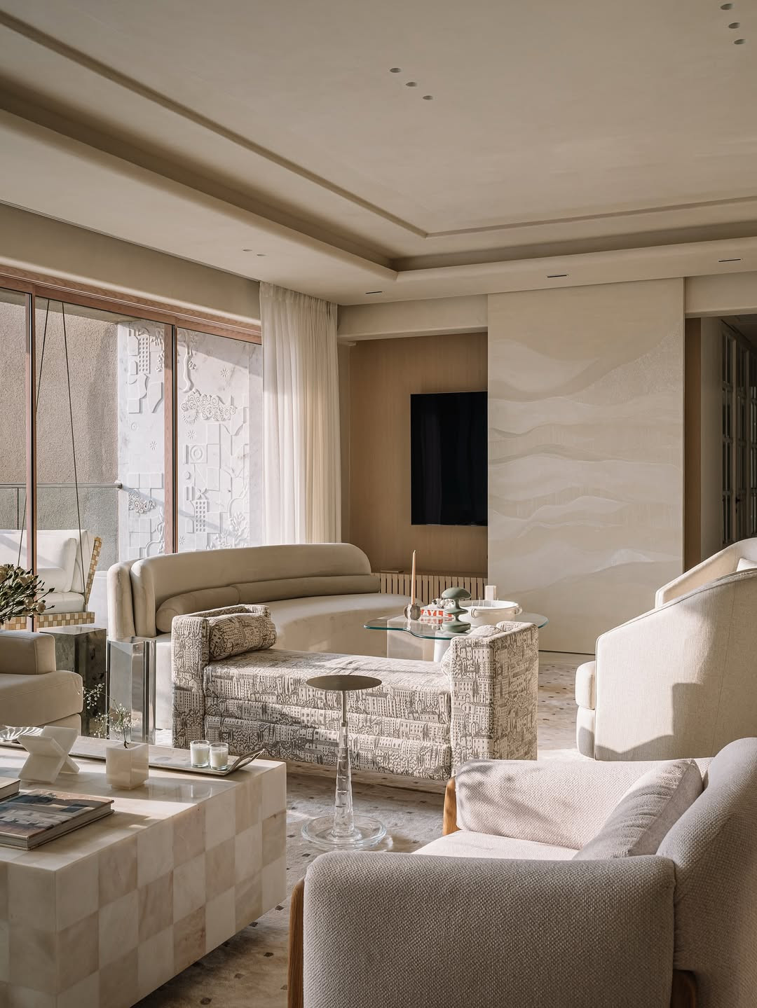 The living room is split into two seating clusters that encourage flexible gatherings