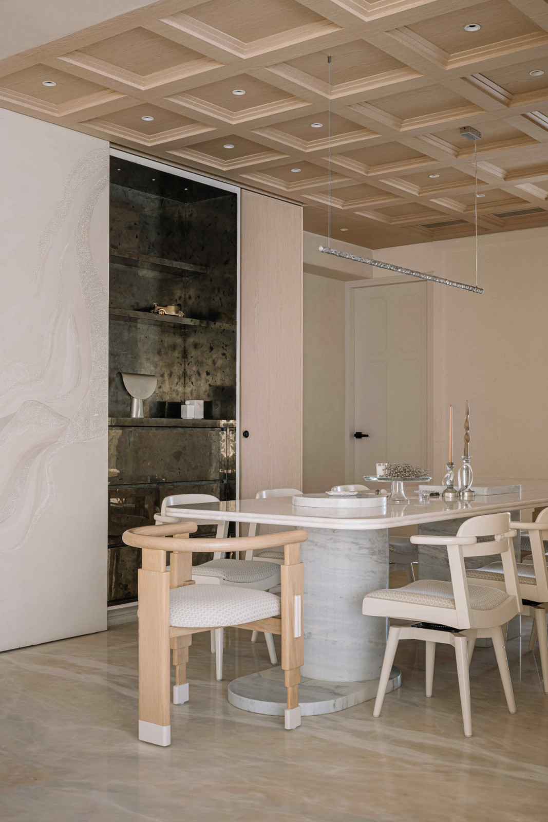 The dining table with marble pedestals, and dining chairs redesigned to align with the new interiors