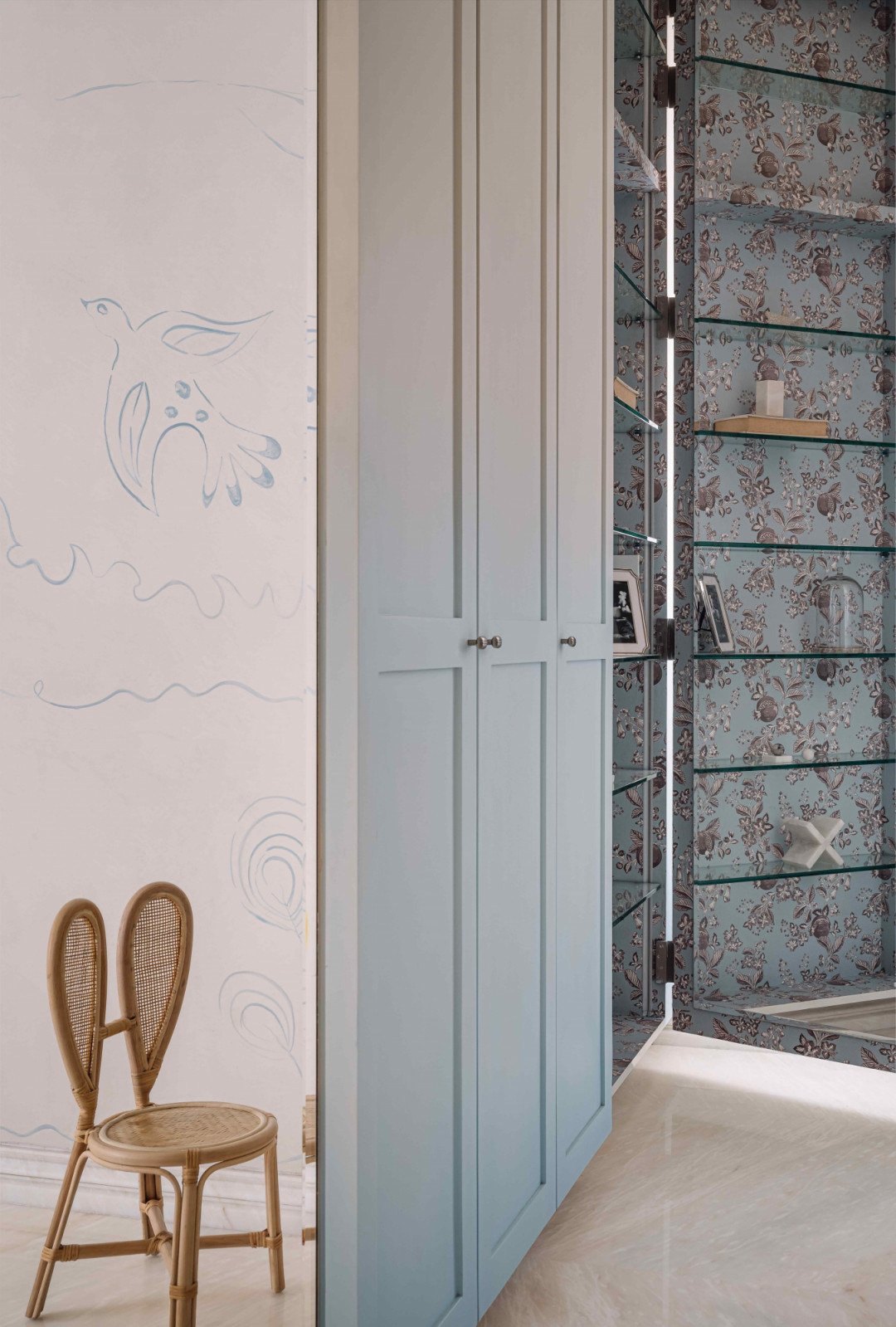 Gradient pastel blue across the wardrobe and as a patterned wallpaper