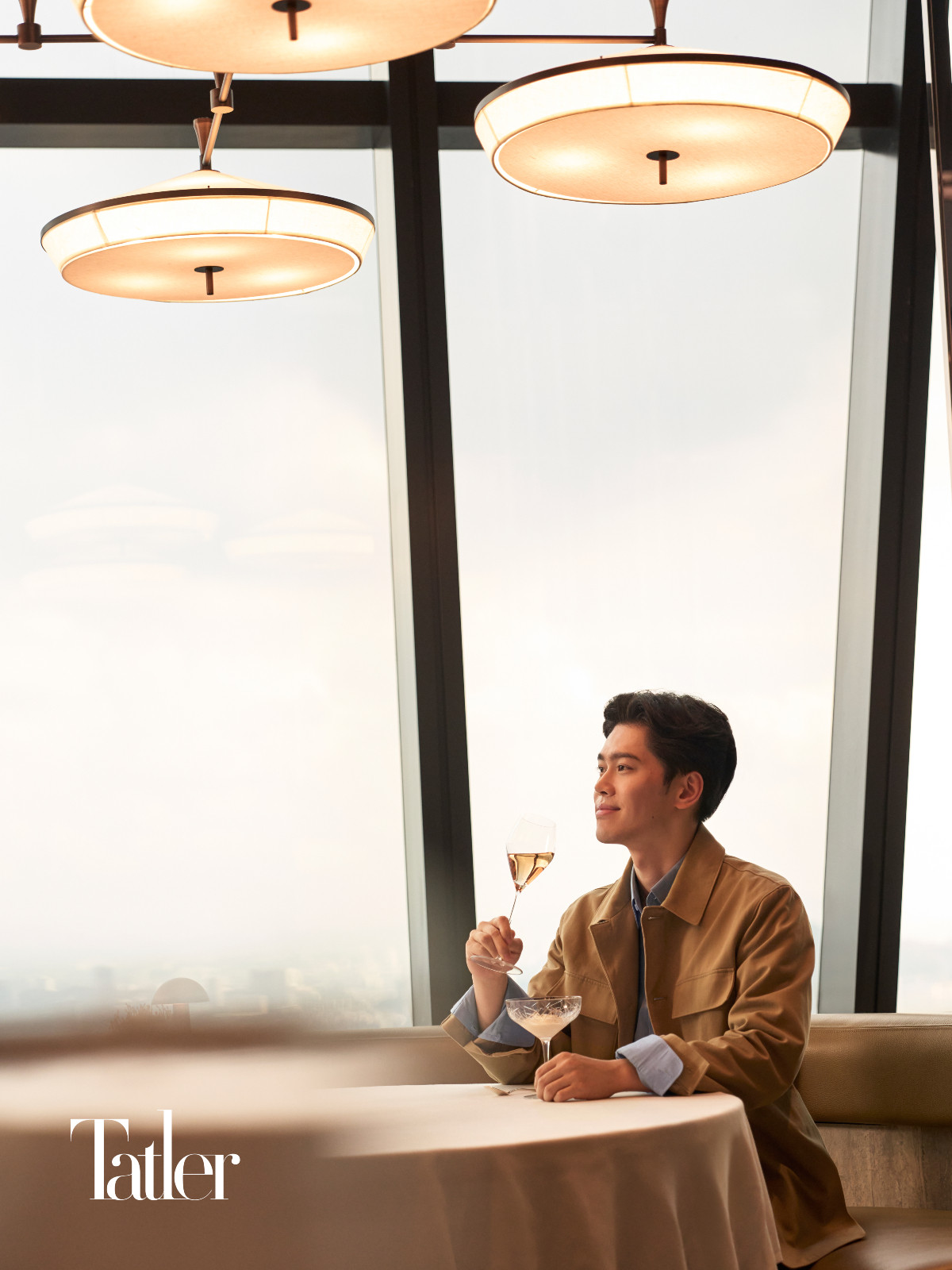 Content creator Vincent Xu having wine window side at the Park Hyatt Kuala Lumpur's Merdeka Grill, located on the 75th floor