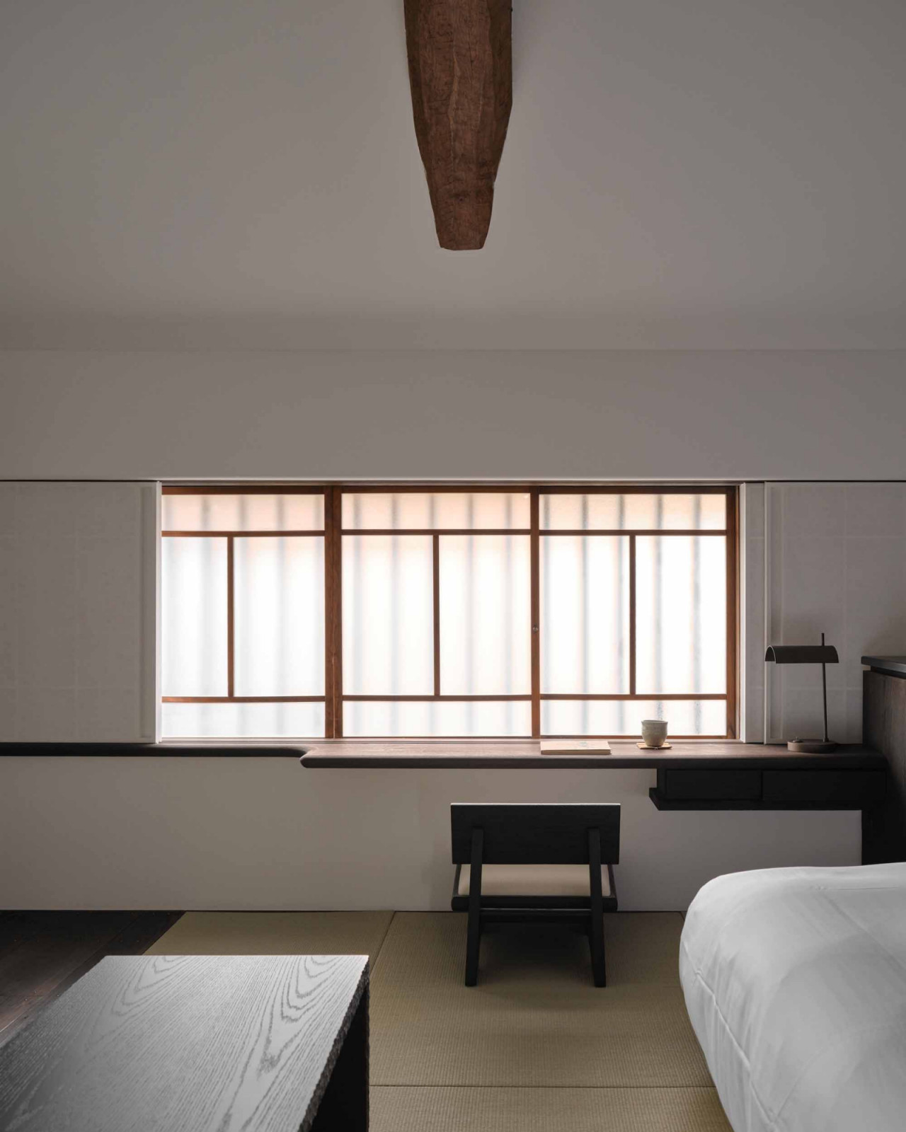 A window ledge and low chair invite guests to sit by the window and admire the view from the standard room