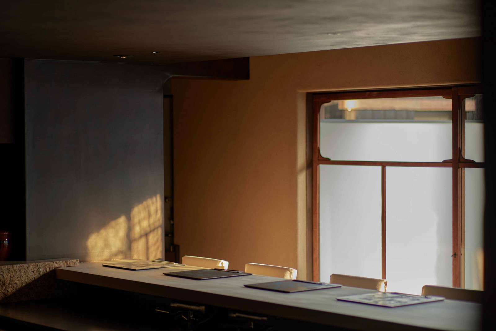The moody lighting filters through Yoruya’s dining area