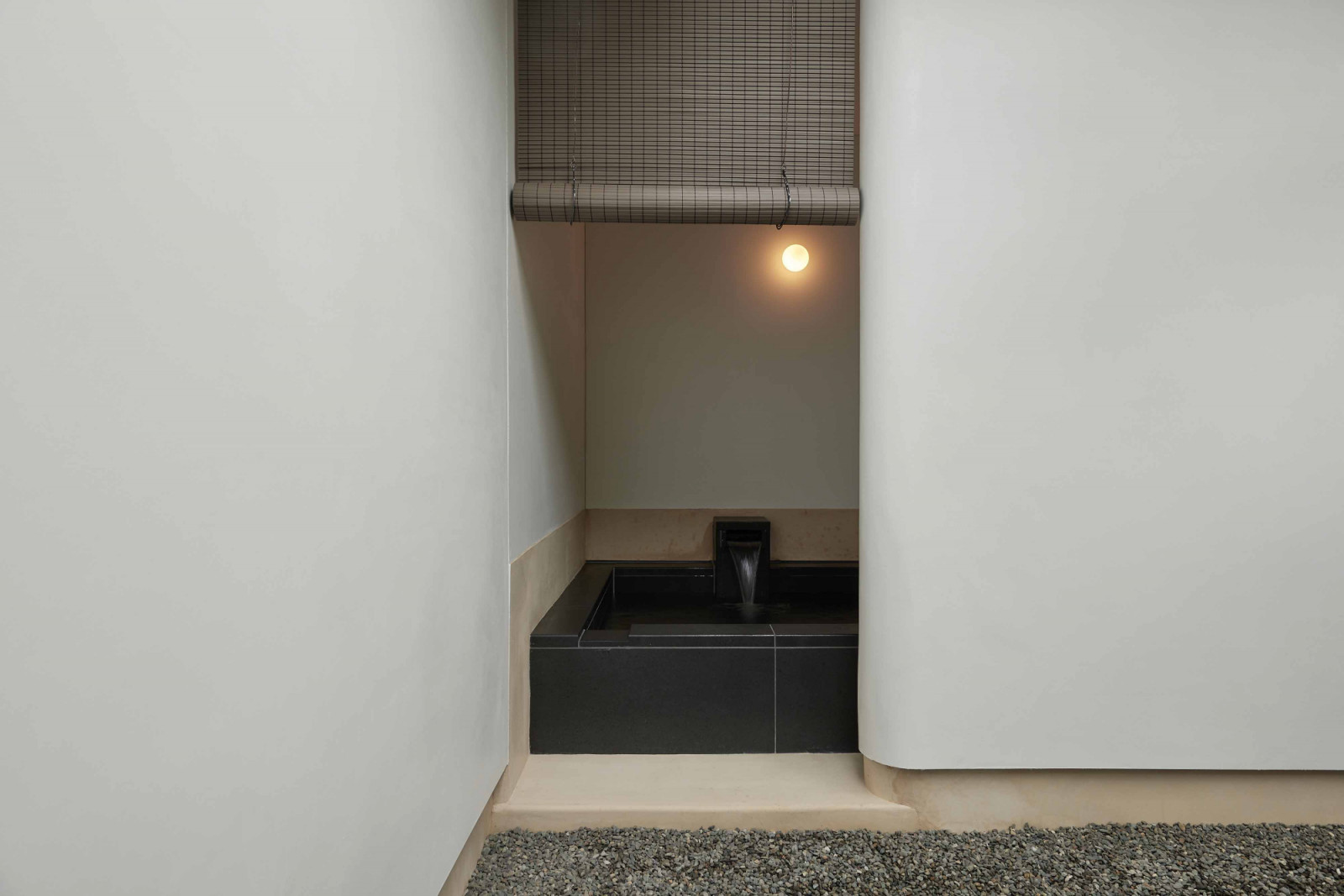 The junior suite’s outdoor bath peeking between lime plastered walls