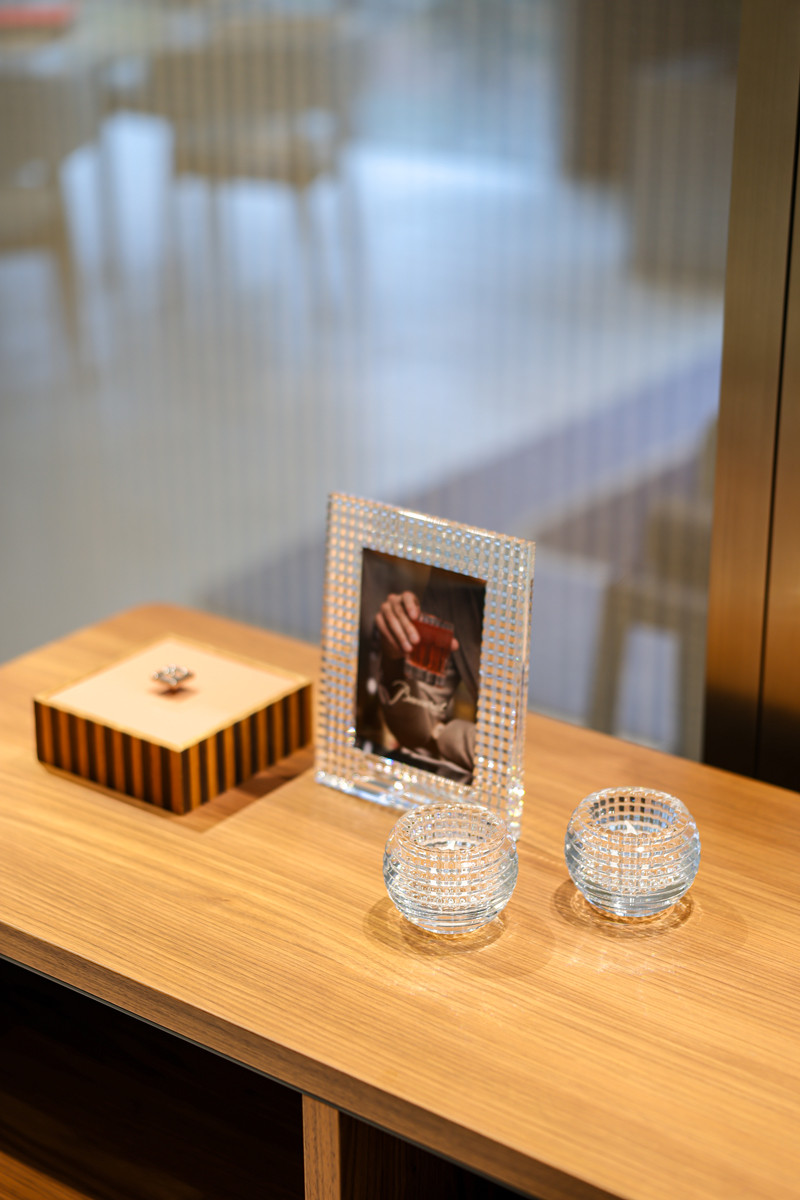 Crystal votives and a photo frame from Baccarat’s Eye collection showcase the brand’s signature faceted cuts, designed to refract light and elevate everyday moments