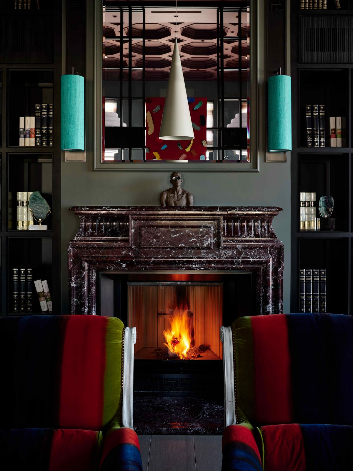 The wood-burning marble fireplace and floor-to-ceiling bookshelves (Photo: Sergey Ananiev)
