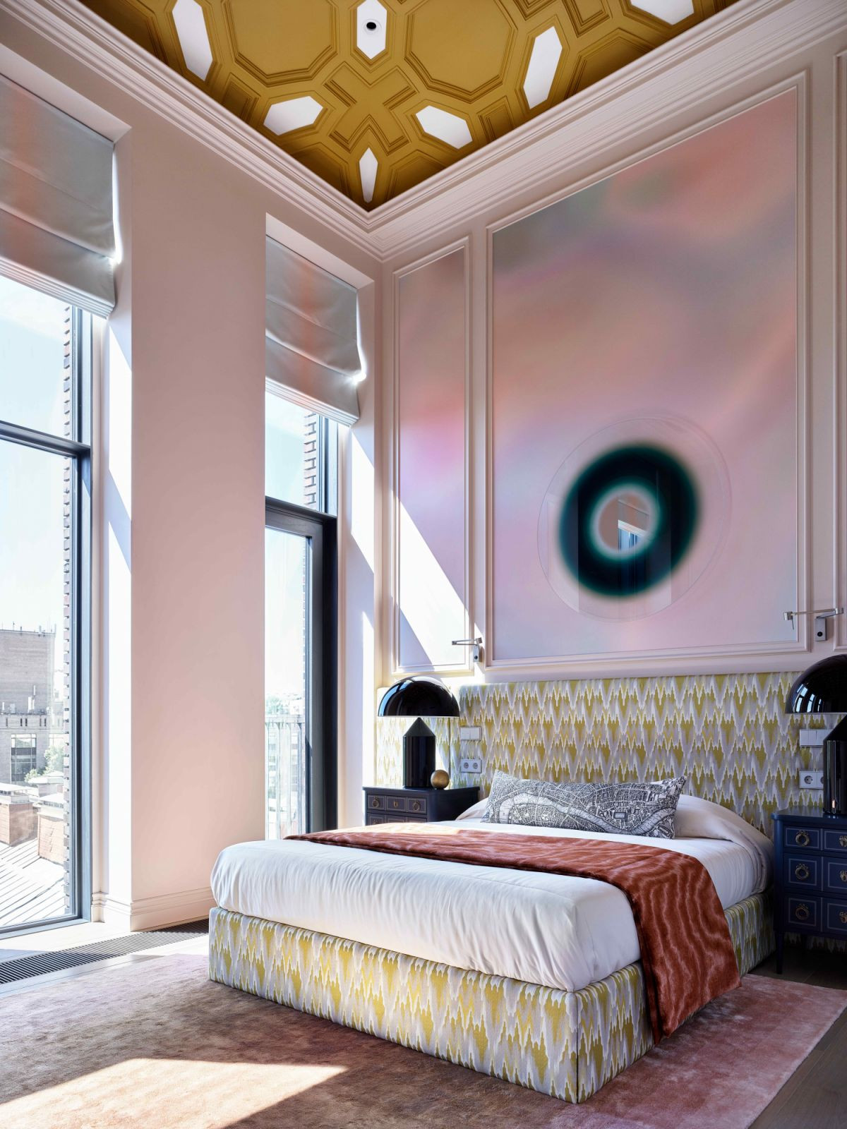 The secondary bedroom features hues of pink with a mustard coffered ceiling overhead (Photo: Sergey Ananiev)